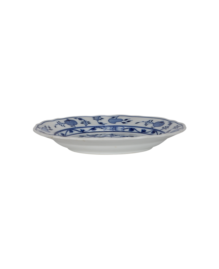 Vintage French porcelain Onion Plate, side view displaying scalloped edge and blue floral pattern.