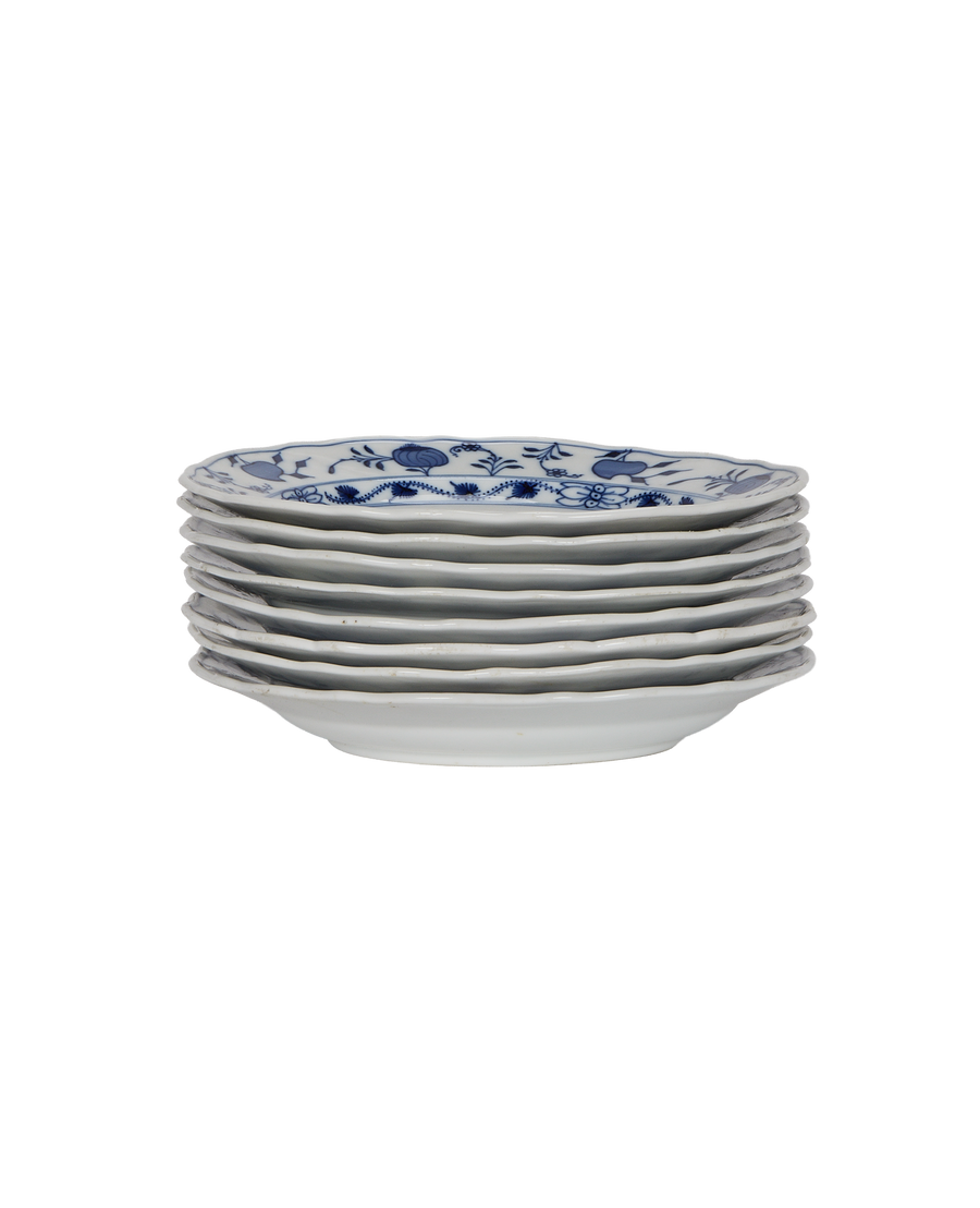Stacked vintage French Onion Plates in bulk, showing blue floral pattern detail.