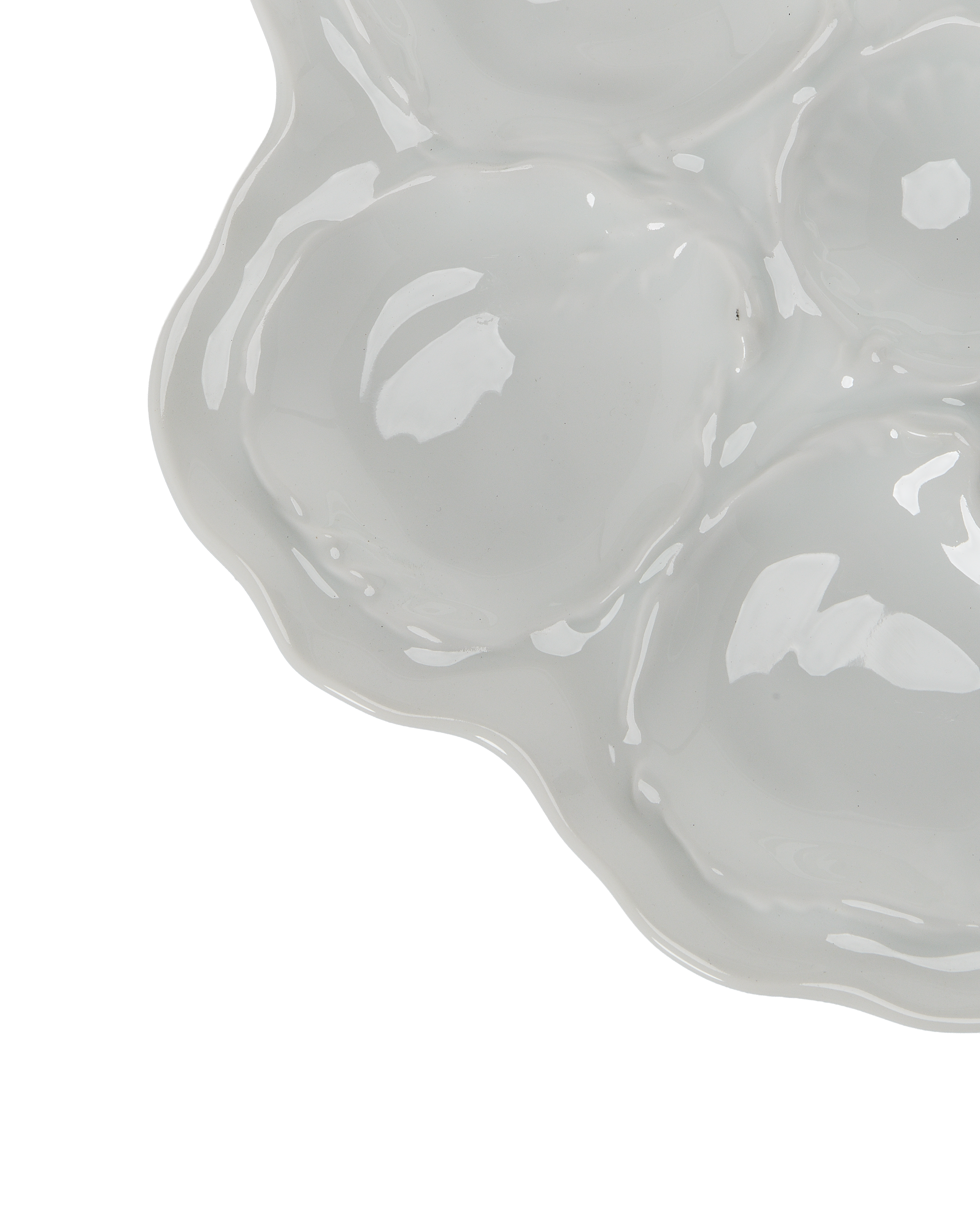 Close-up of vintage Limoges oyster plate, showing textured wells and wavy edge detail.