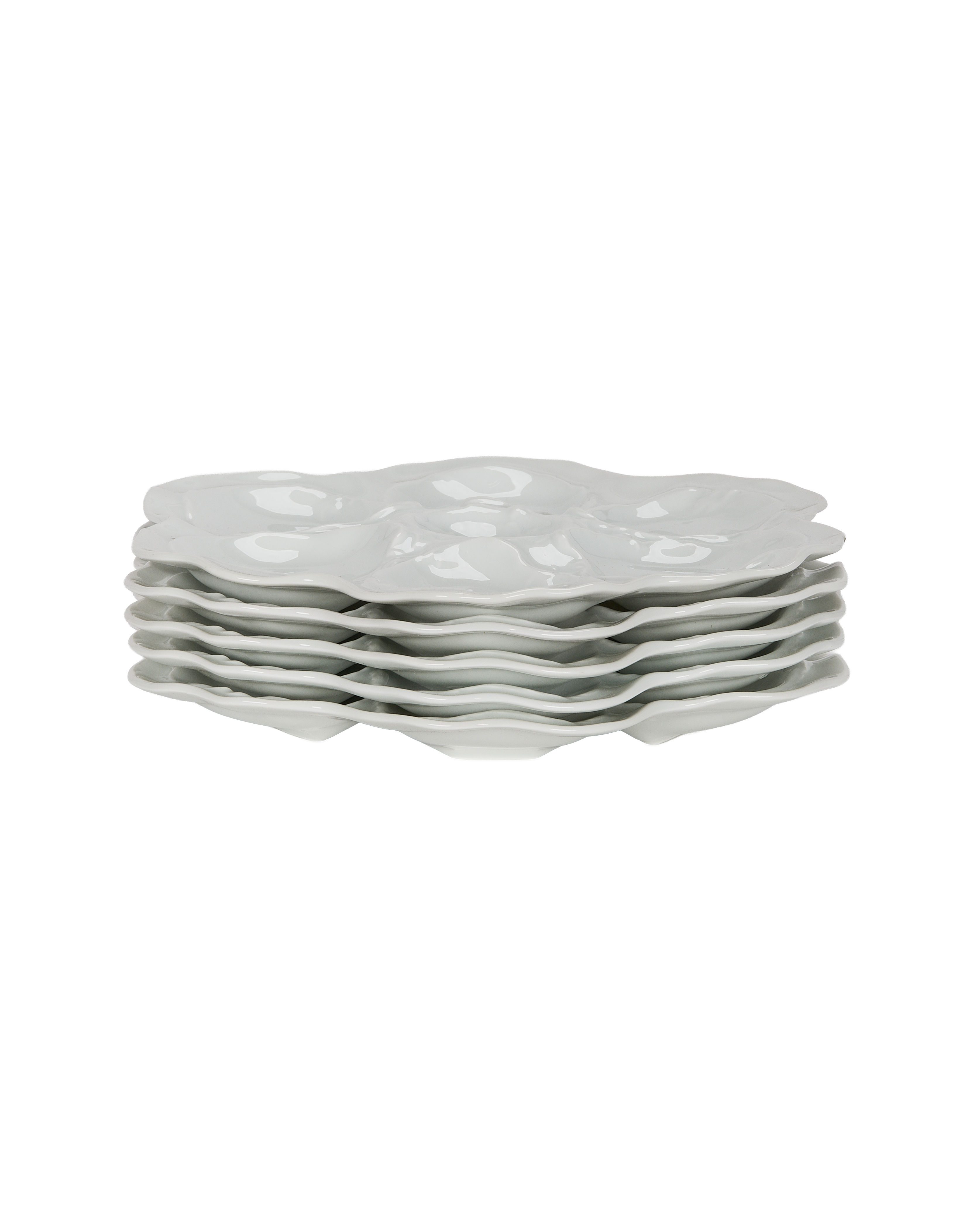 Stacked white Limoges oyster plates, six vintage French porcelain dishes, showing curved edges.