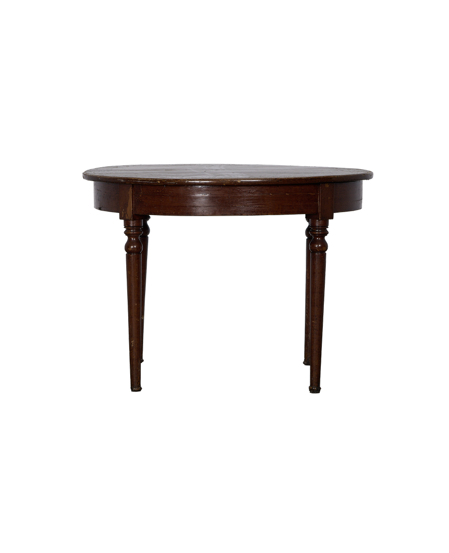 Vintage French oak round table, showing dark wood grain and turned legs from a side angle.
