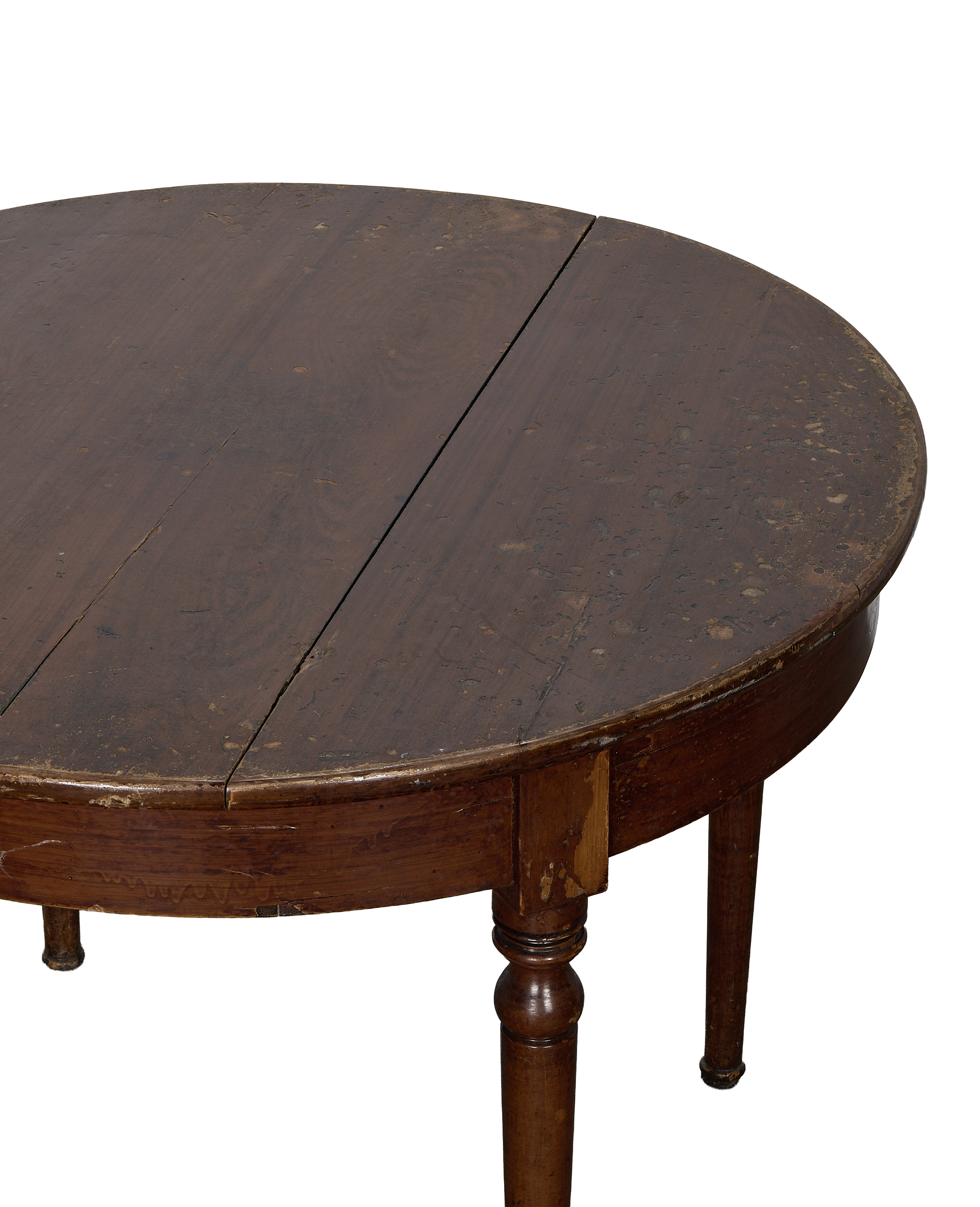 Close-up of vintage French oak round dining table with distressed tabletop and turned legs.