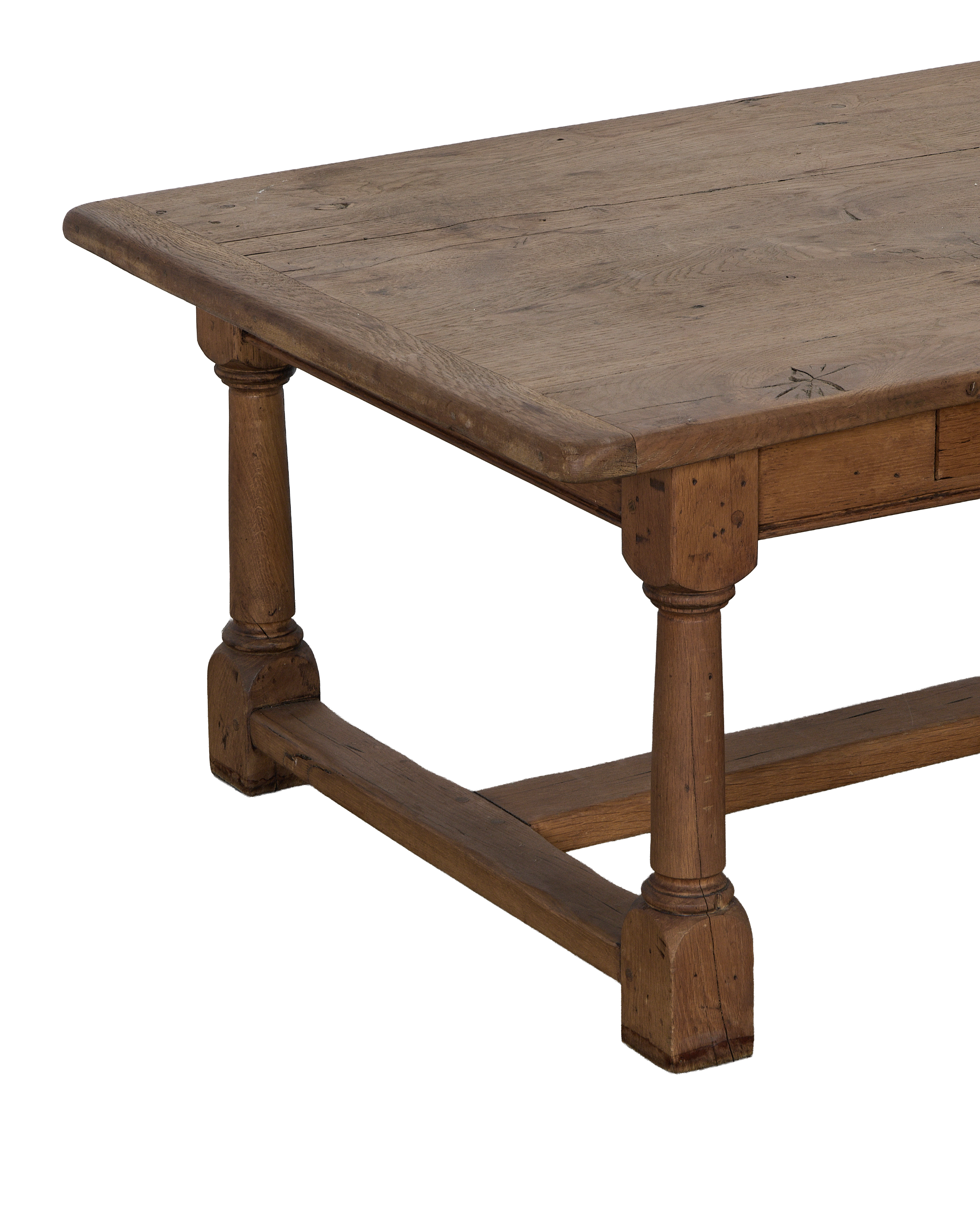 Vintage French oak Draper style coffee table showcasing turned legs and weathered tabletop texture.