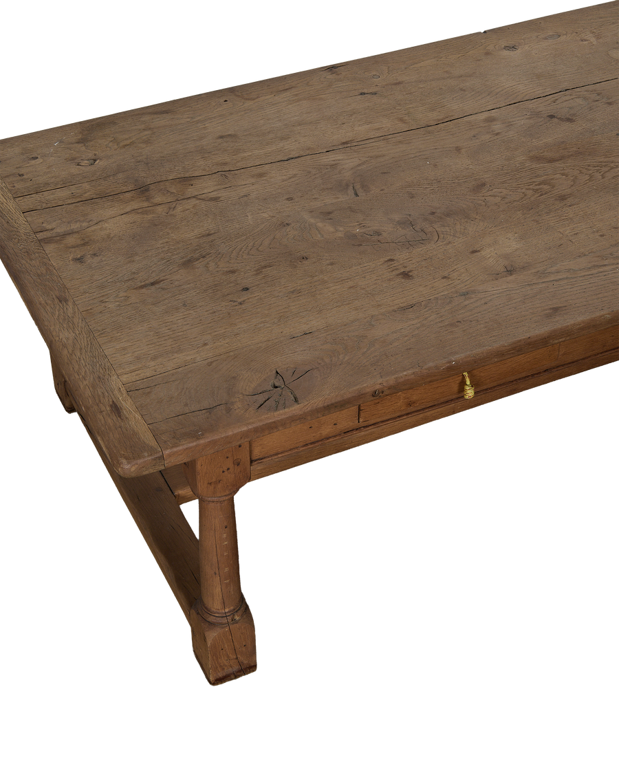 Vintage French Draper style oak coffee table, showcasing tabletop texture, drawer, and turned leg.
