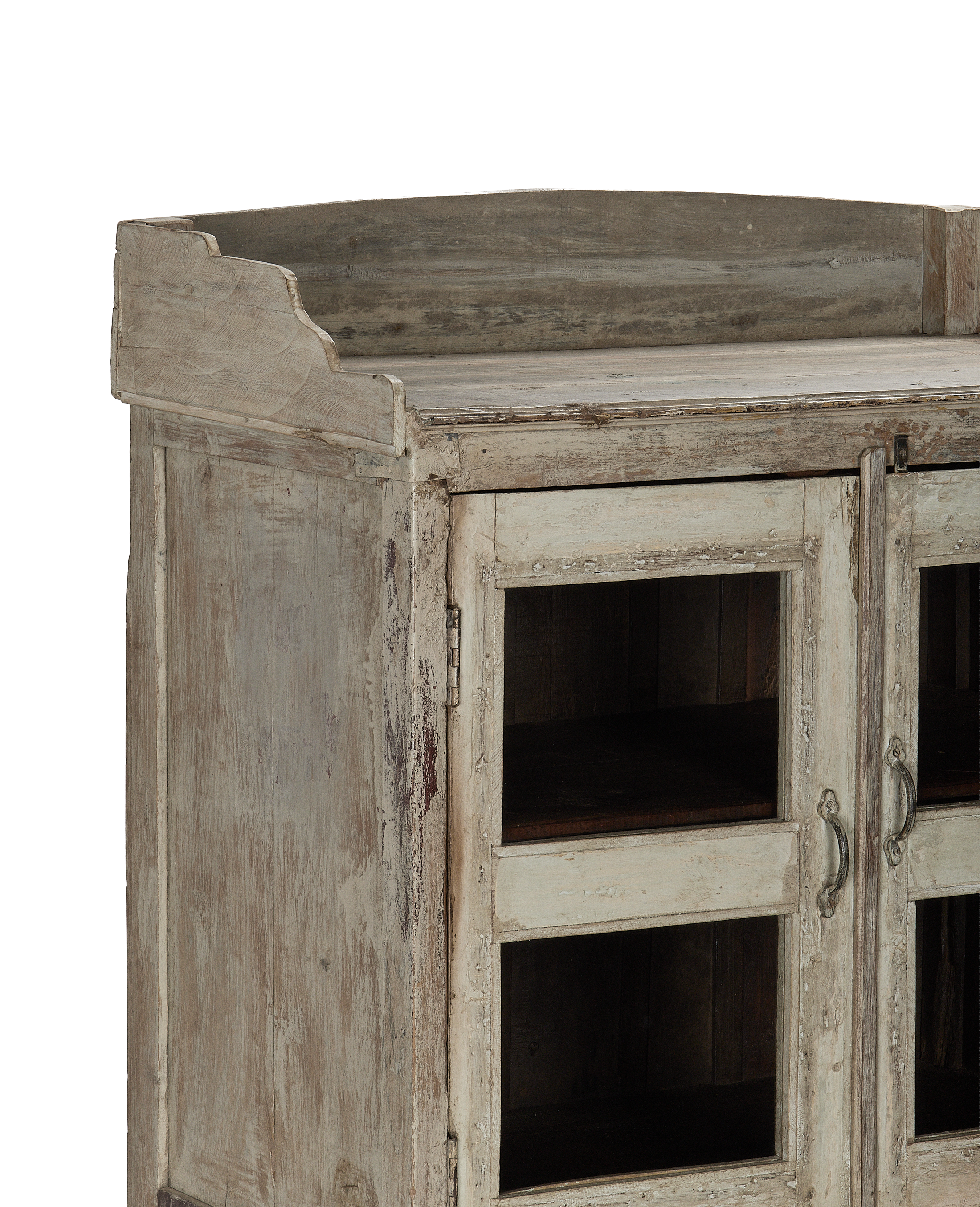 Vintage bleached oak cabinet from India, displaying decorative carved top and distressed finish