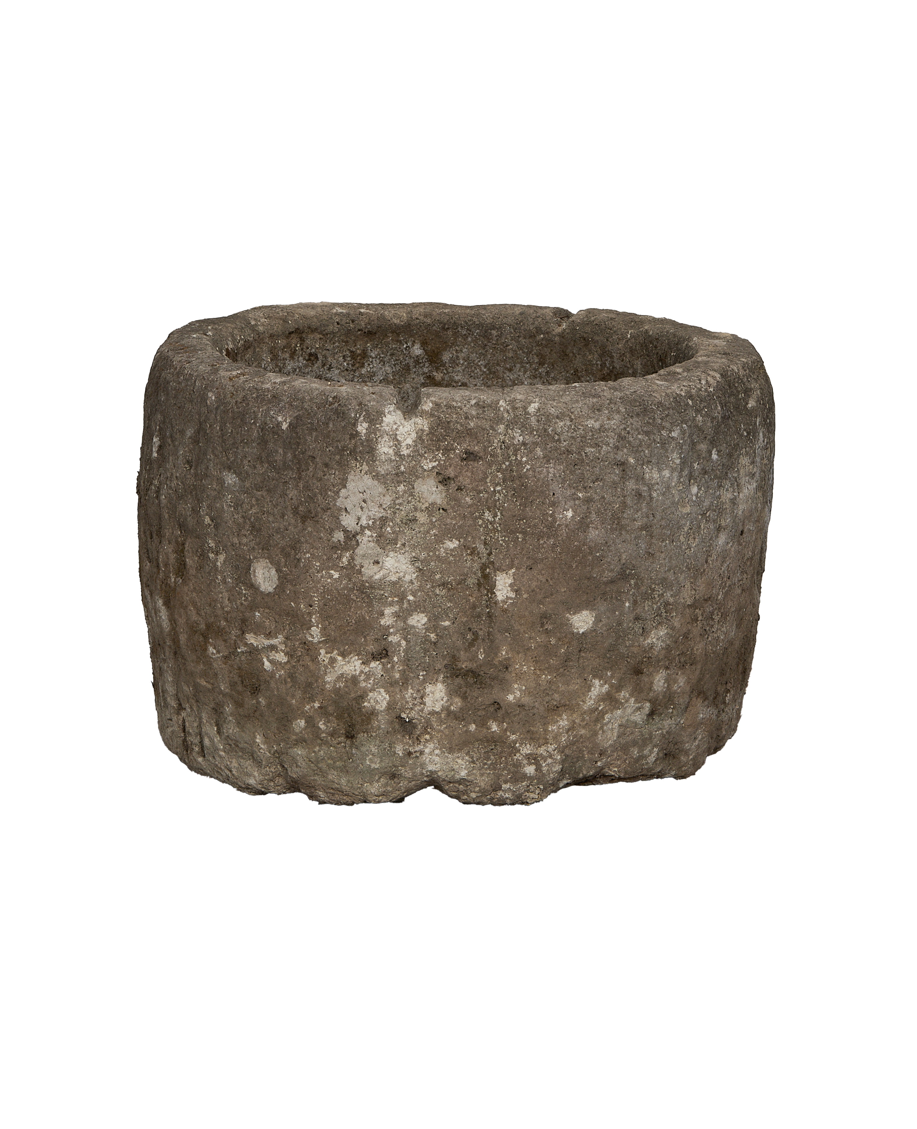 Vintage round Indonesian limestone trough showing weathered exterior texture and rugged edge detail.