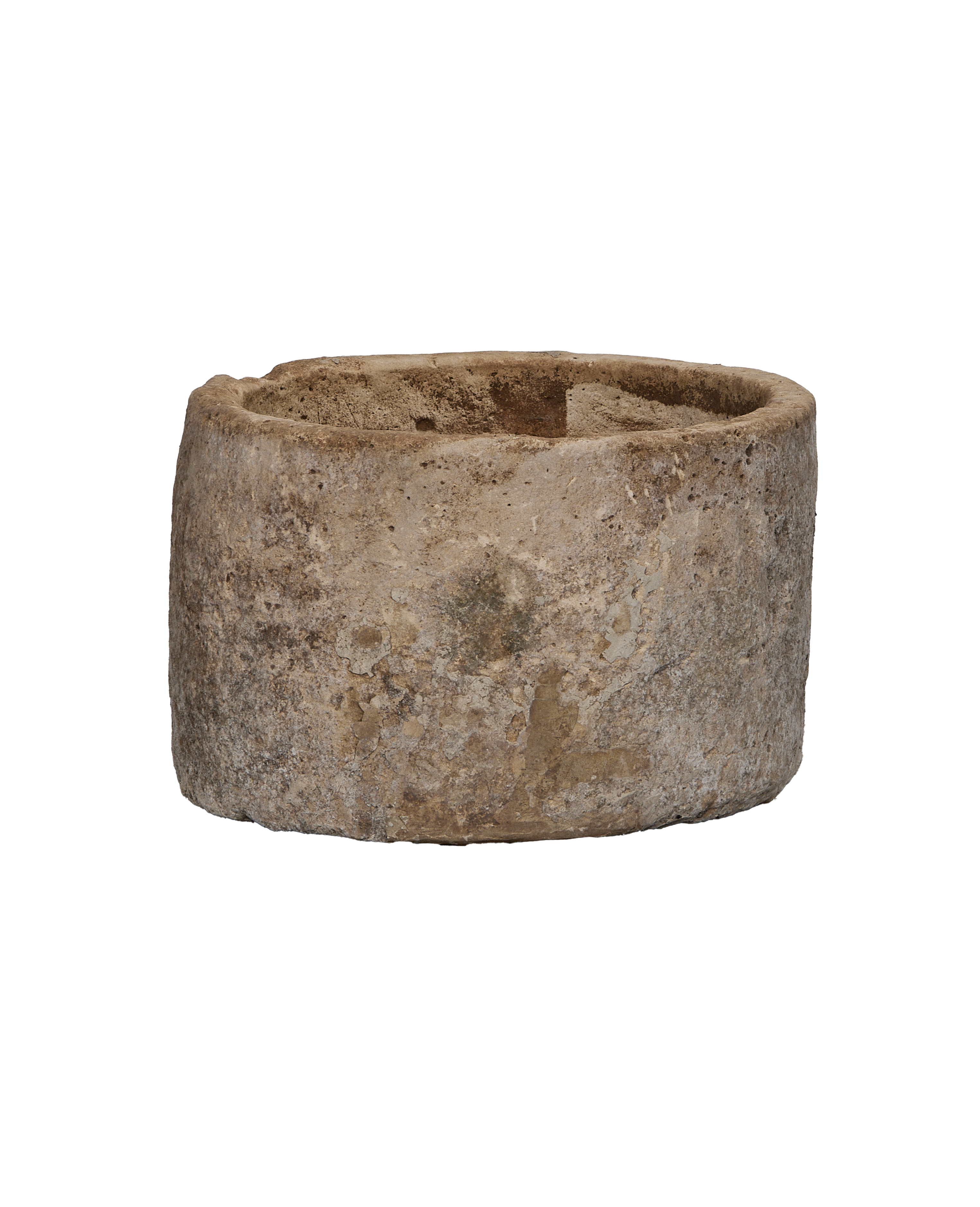 Vintage Indonesian round limestone trough, showing weathered side and rough interior texture.