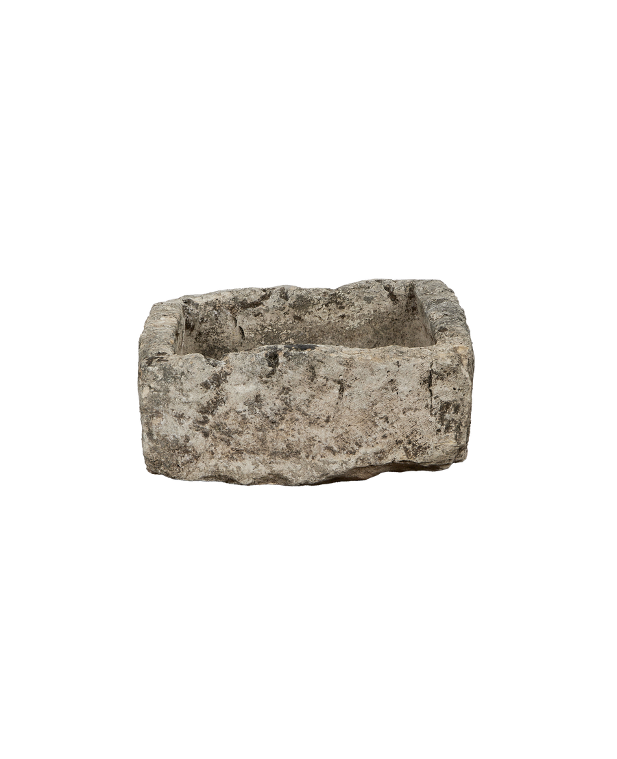 Vintage rectangular limestone trough, weathered surface texture visible