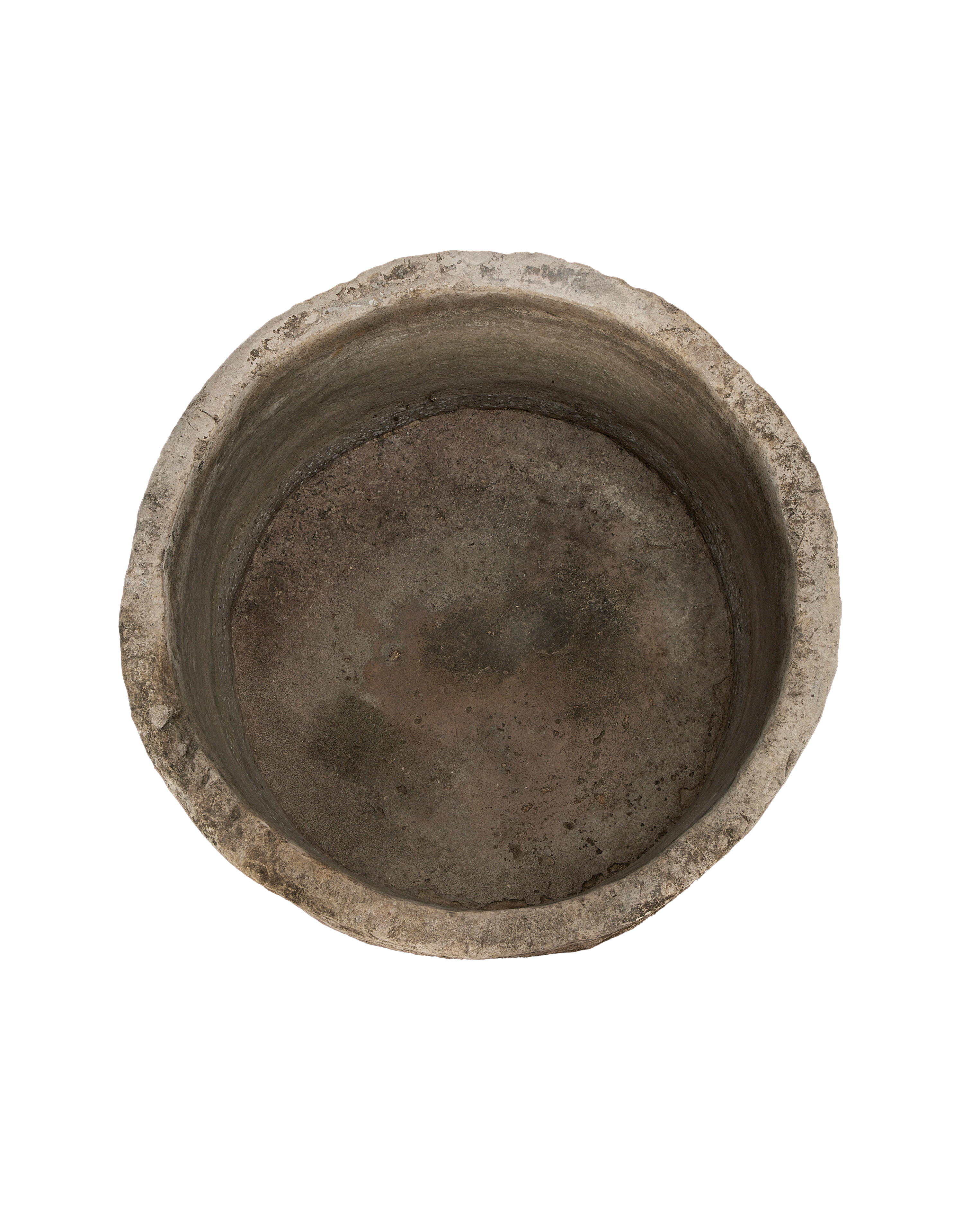 Vintage round limestone trough, top-down view showing weathered interior and