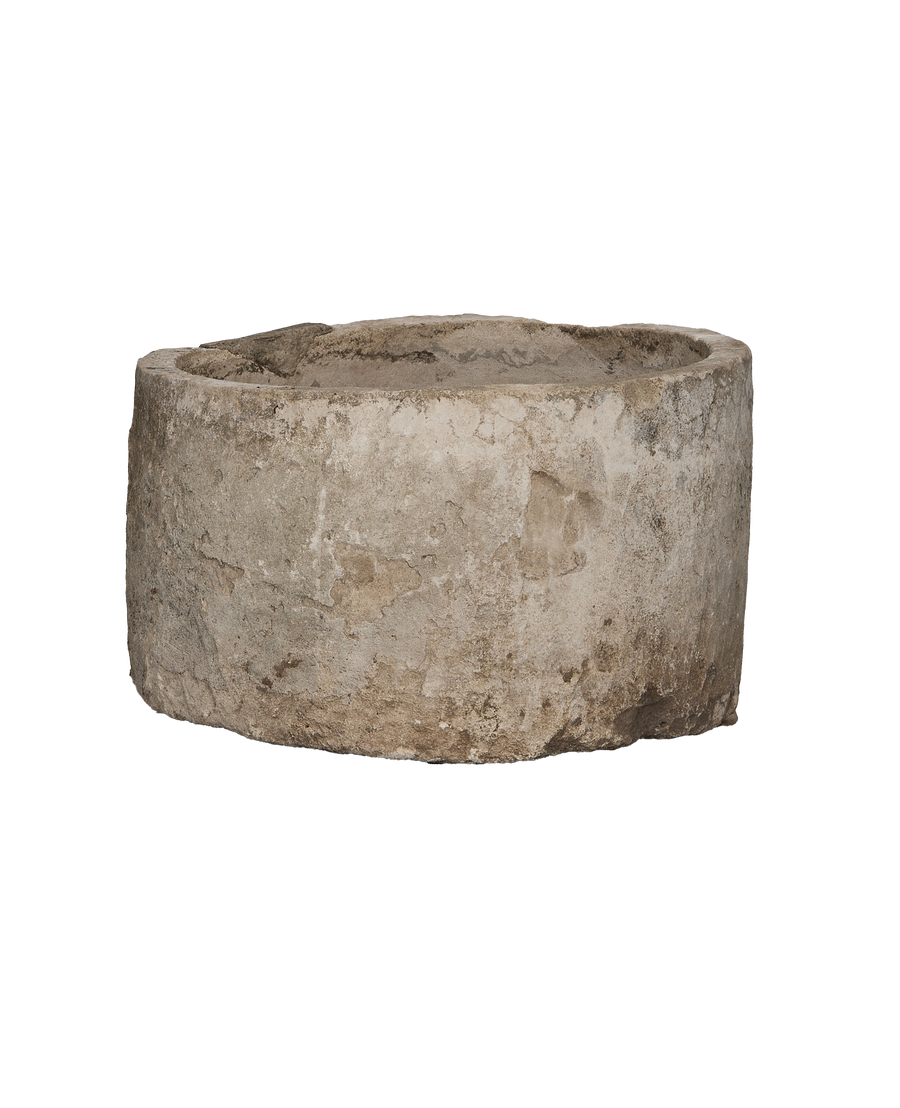 Vintage round limestone trough, close-up of textured exterior showing natural