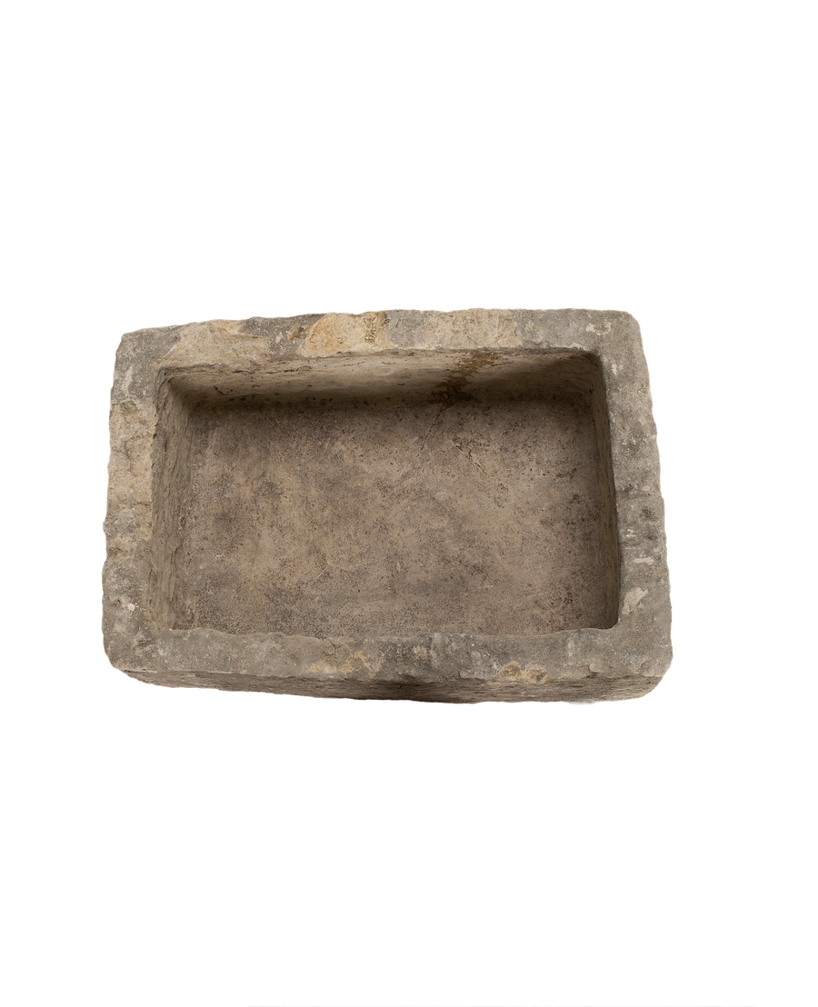 Vintage Indonesian limestone trough, top-down view highlighting textured interior and rough-hewn edges.