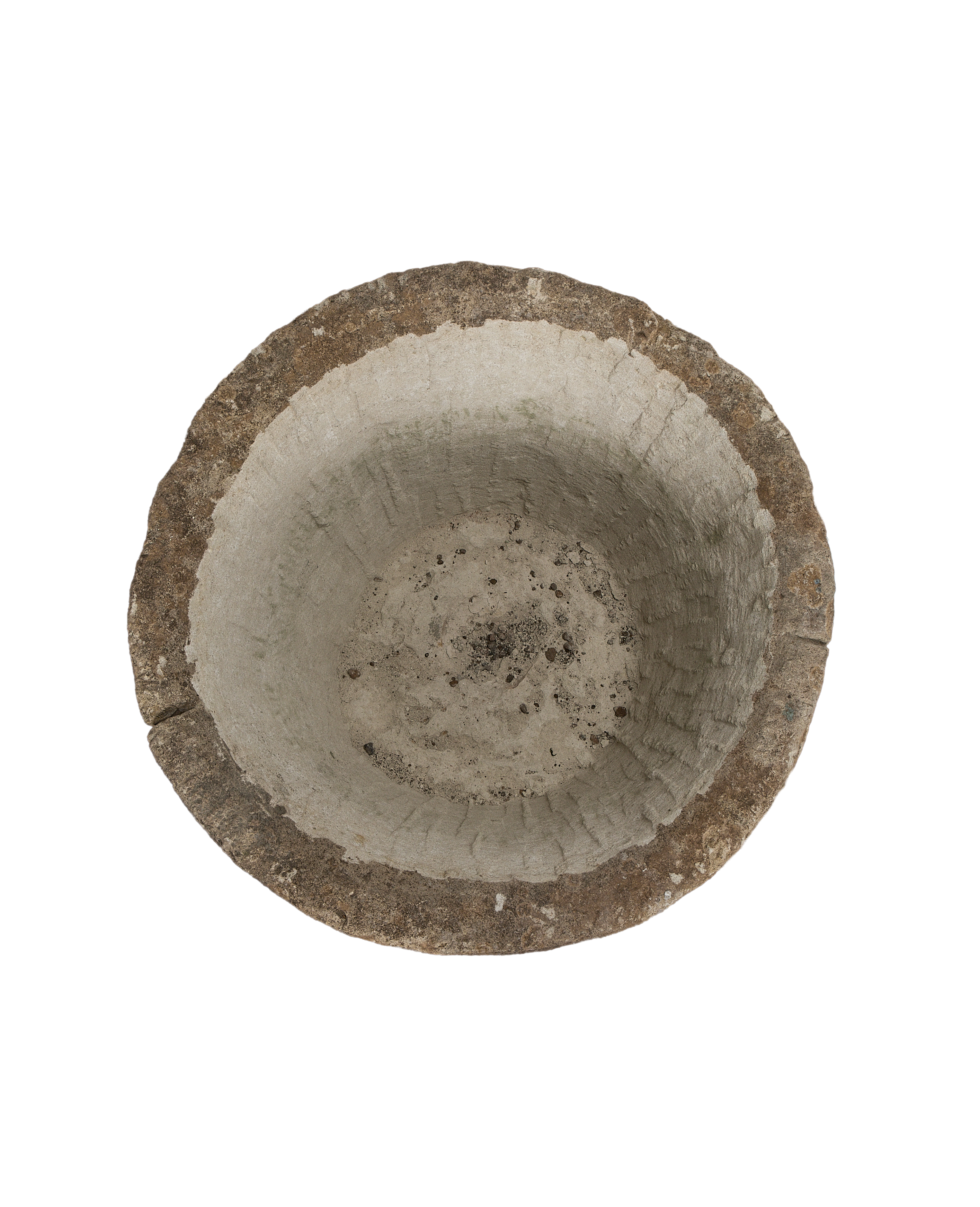 Vintage round limestone trough, top-down view showing weathered interior texture and rough rim.