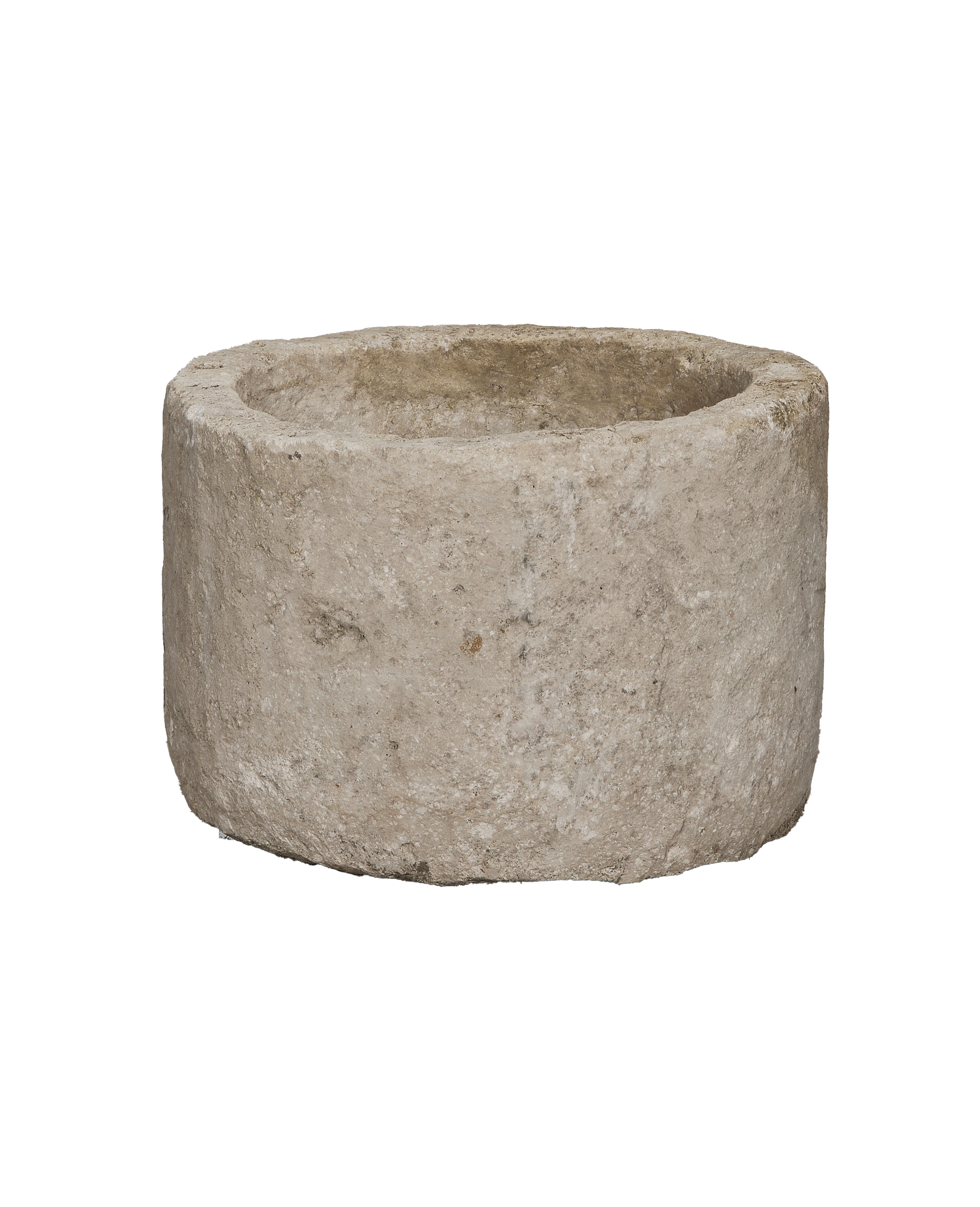 Vintage round limestone trough, side view revealing rustic texture and natural imperfections.
