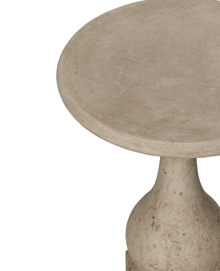 Round cast cement cocktail table, detailed view of textured surface and elegant pedestal base.