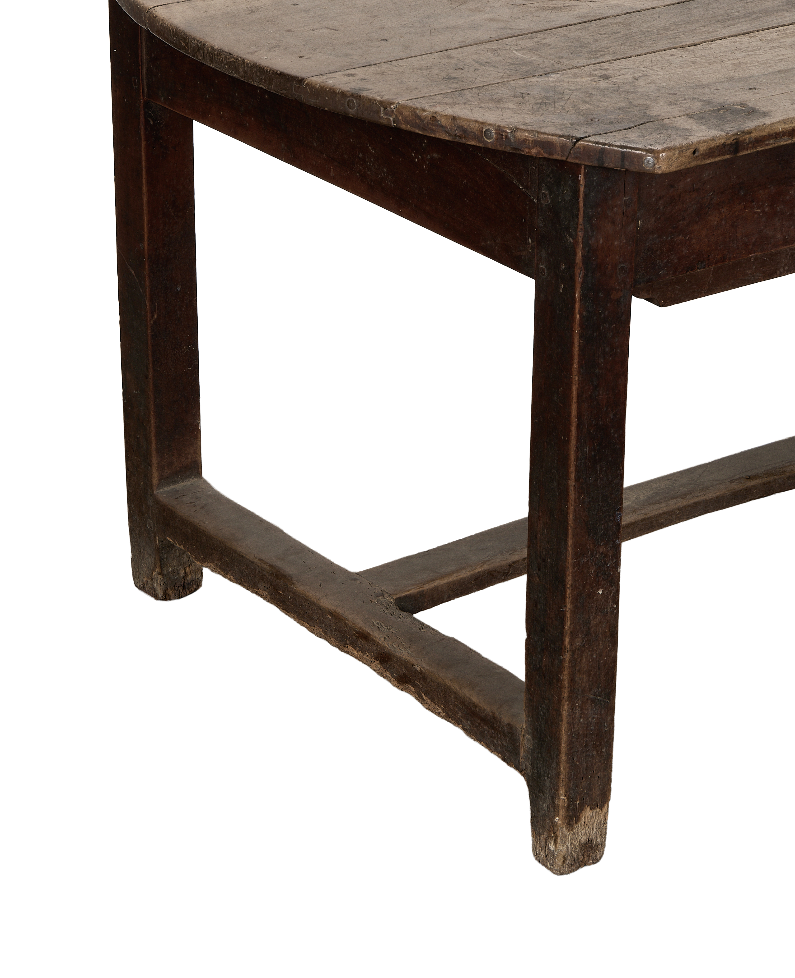 Vintage French oak dining table, close-up of distressed leg, curved edge, and wooden crossbar.