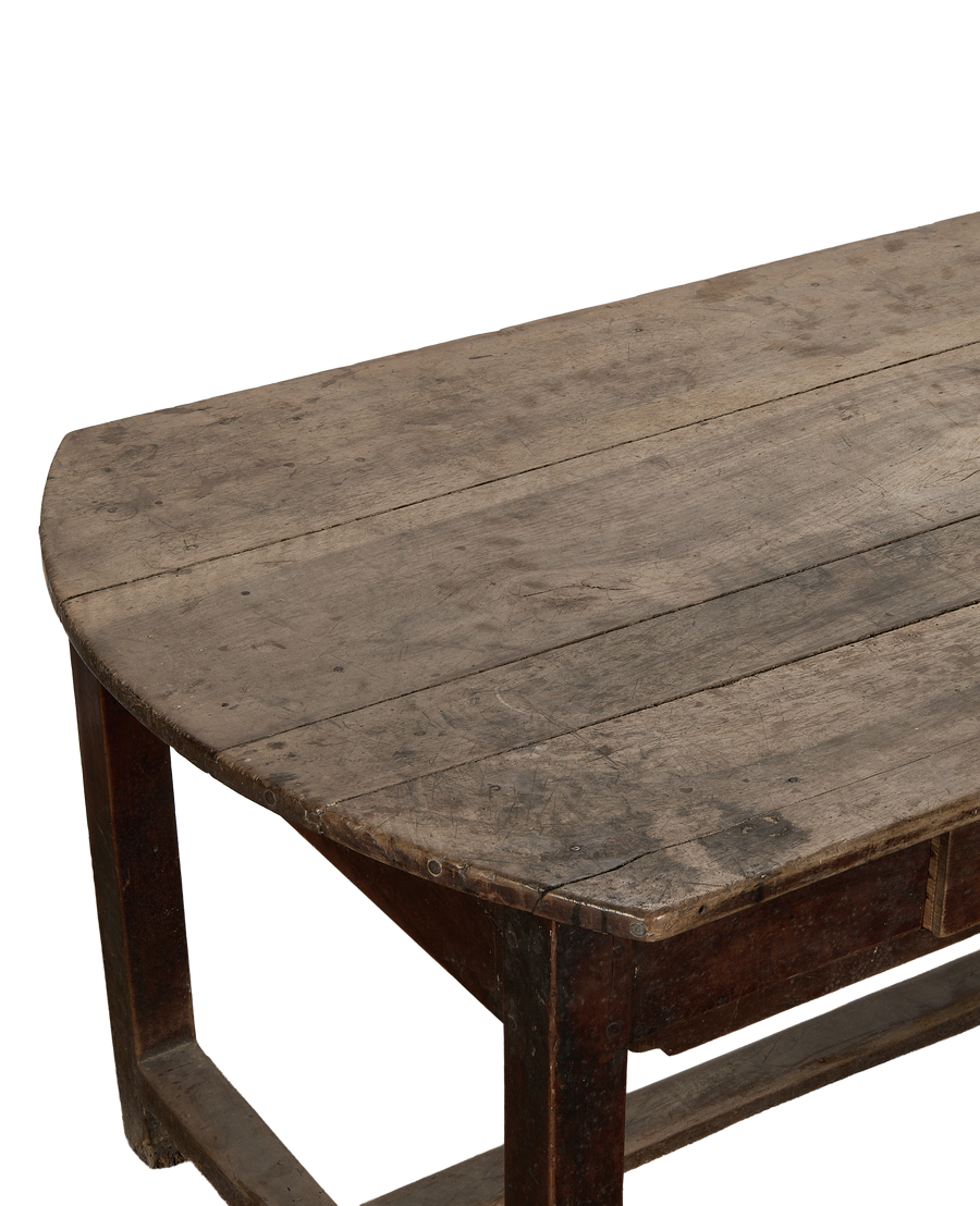 Vintage French oak curved dining table, aged wood grain detail of tabletop.