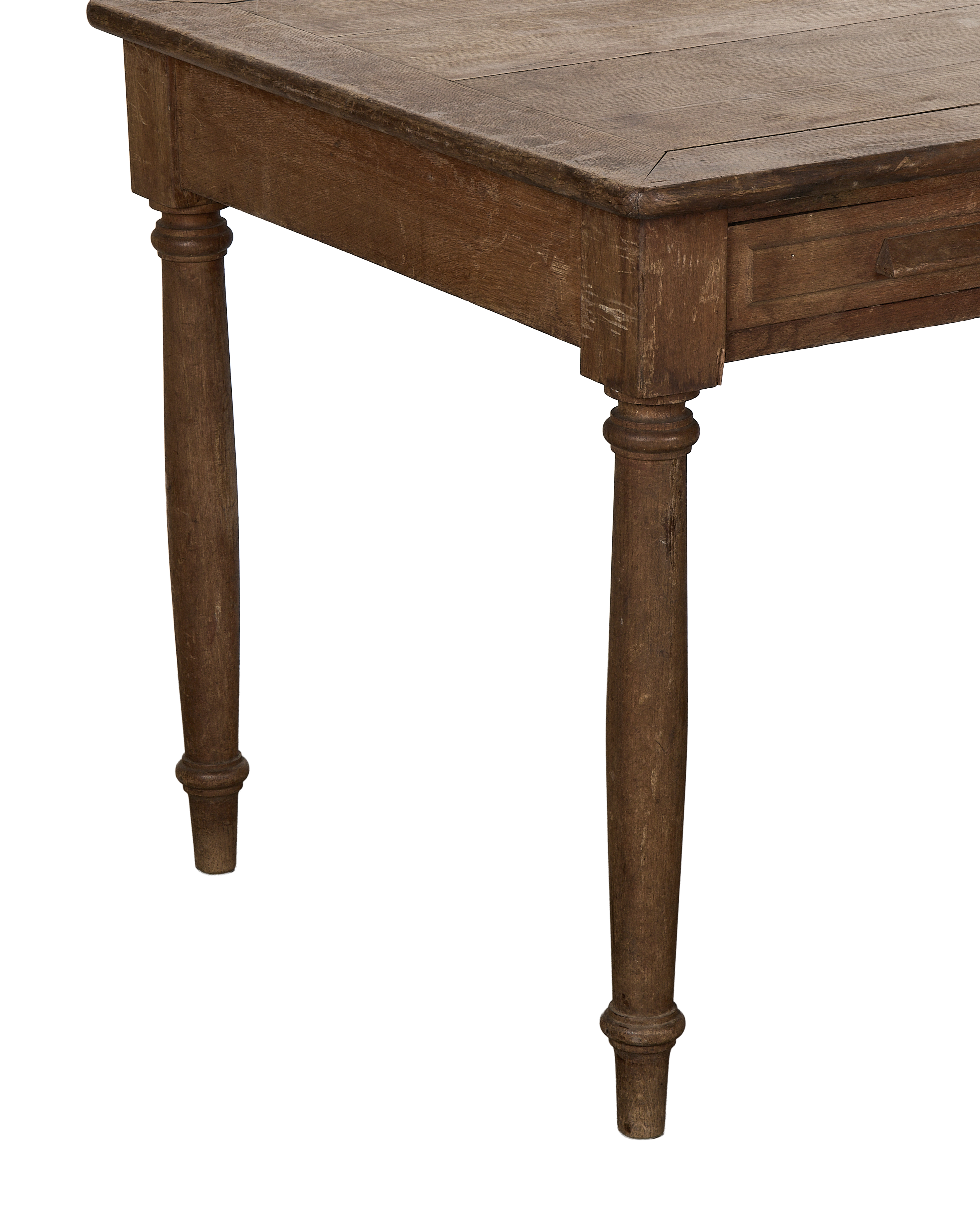 Close-up of vintage French oak farm table, showing turned leg detail and drawer.
