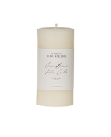 cream cylindrical pillar candle with label