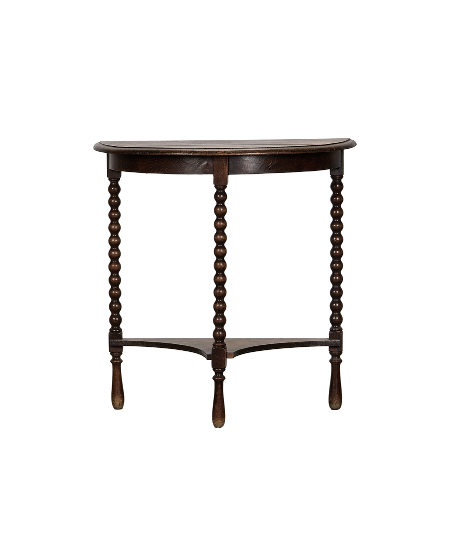 Vintage French oak demilune bobbin table, dark wood, with bottom shelf.