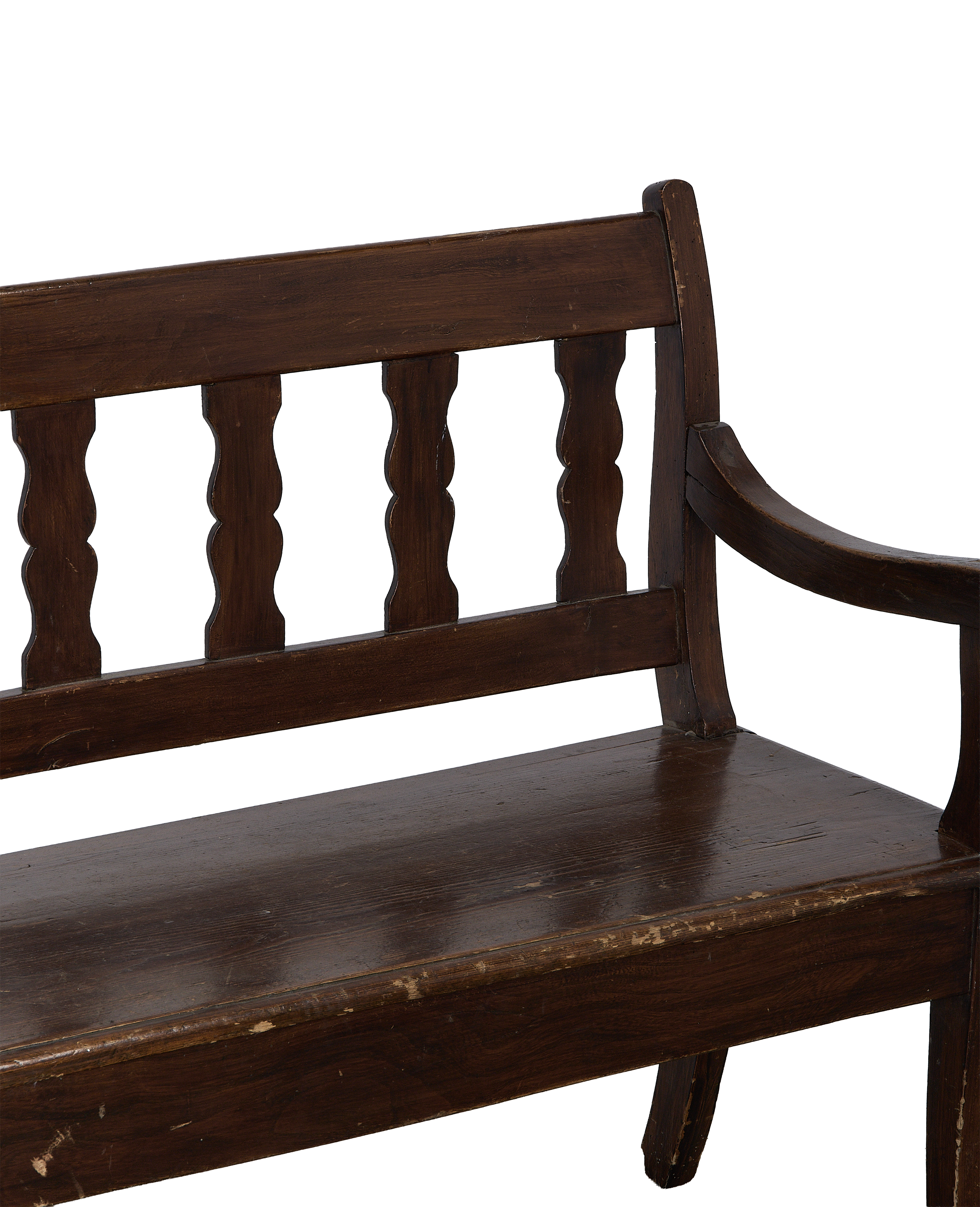 Vintage French oak sitting bench, closeup of distressed seat with scrolled armrest.