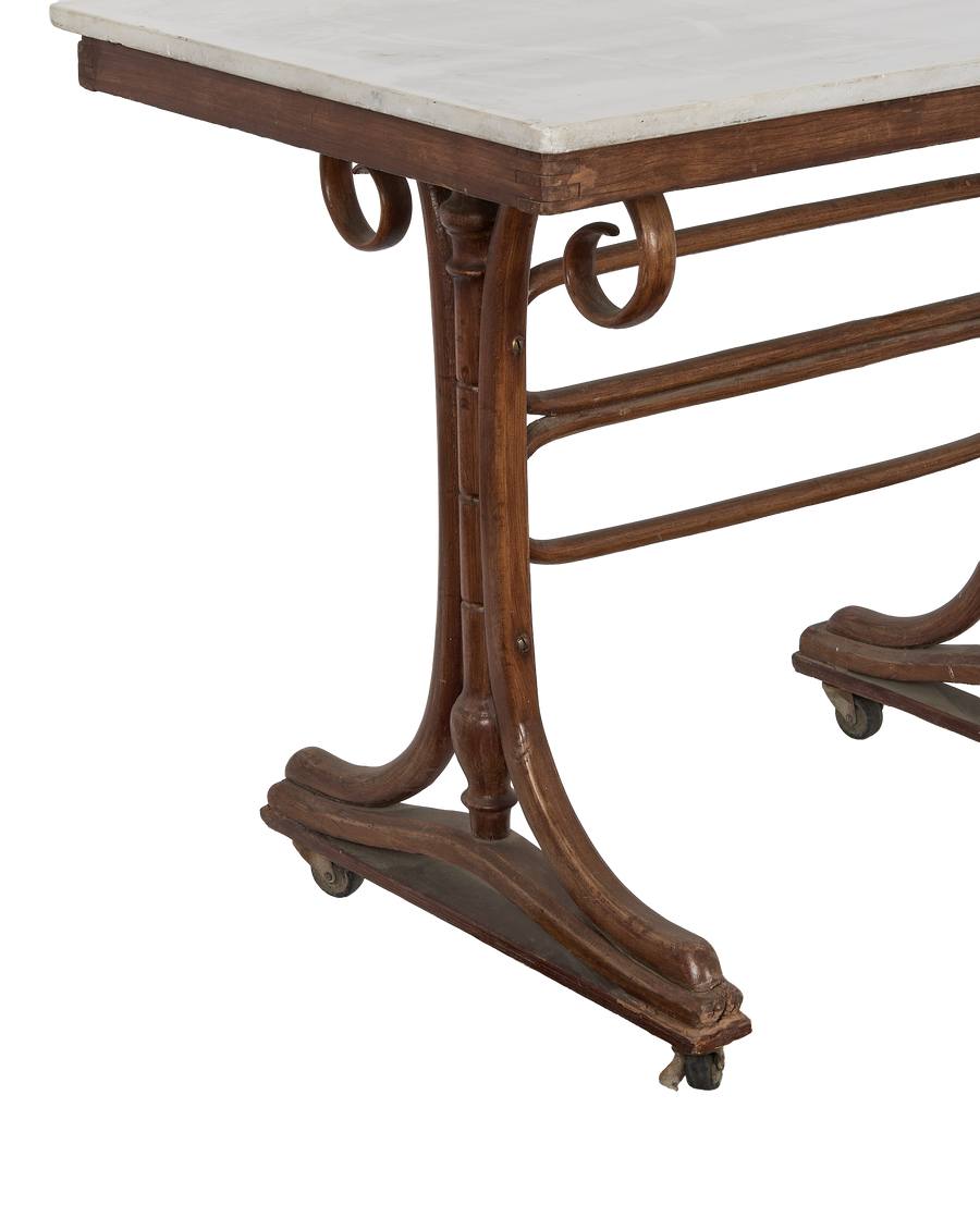 Close-up of vintage French oak Thonet bistro table base, showing casters and detailing.