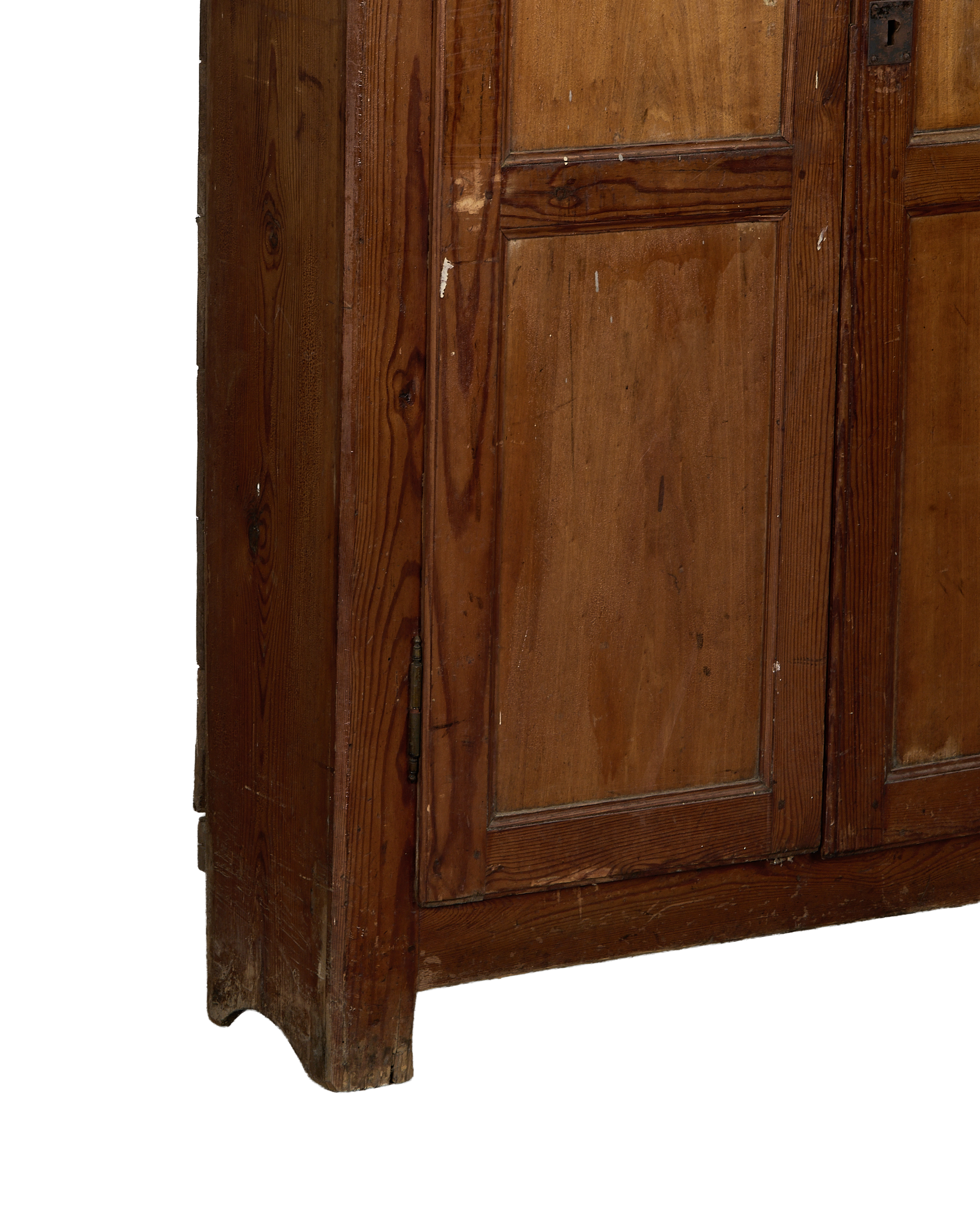Lower left corner of vintage French oak cabinet showing distressed wood finish.