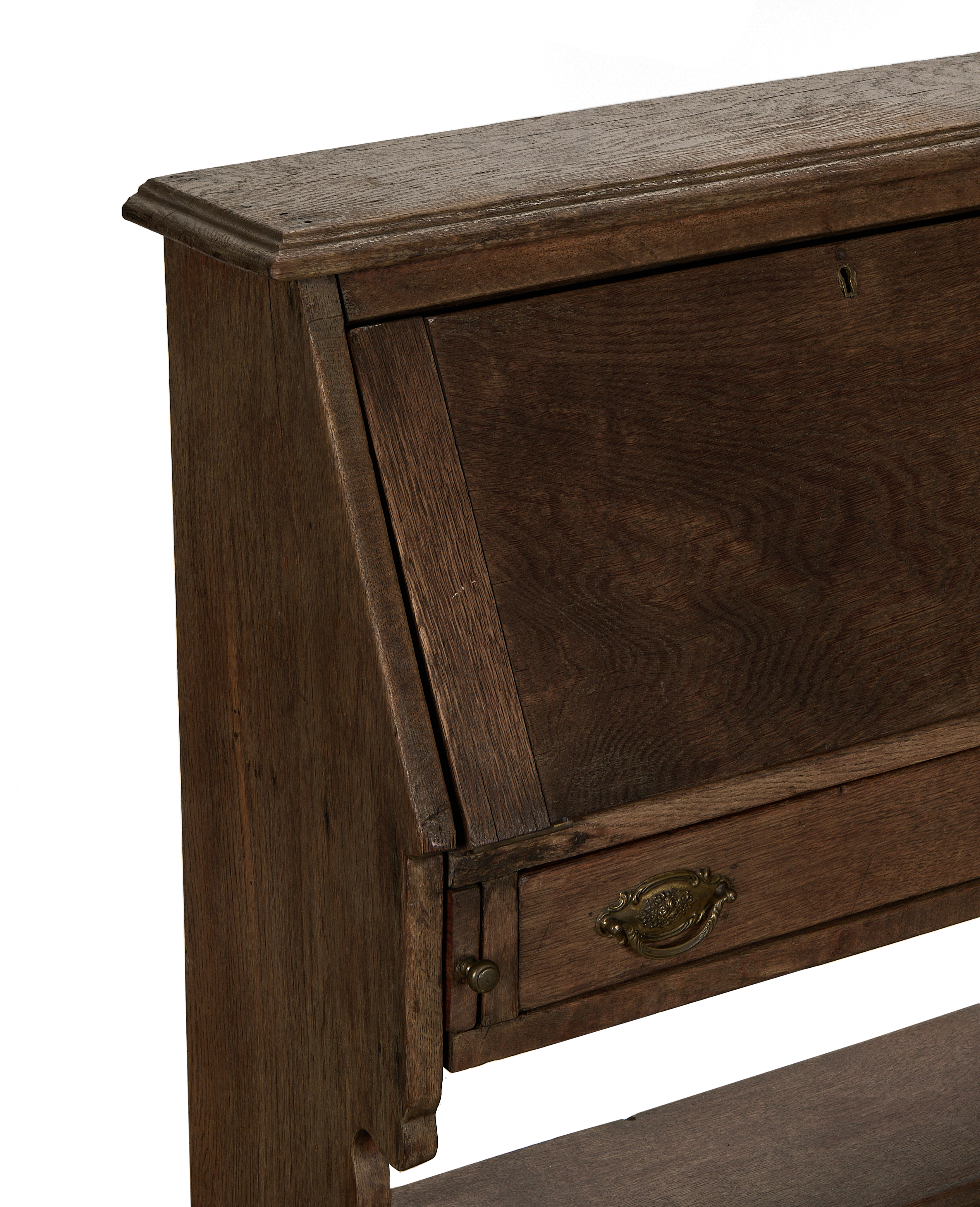Vintage French oak secretary cabinet desk, showing intricate top molding and closed writing surface detail.