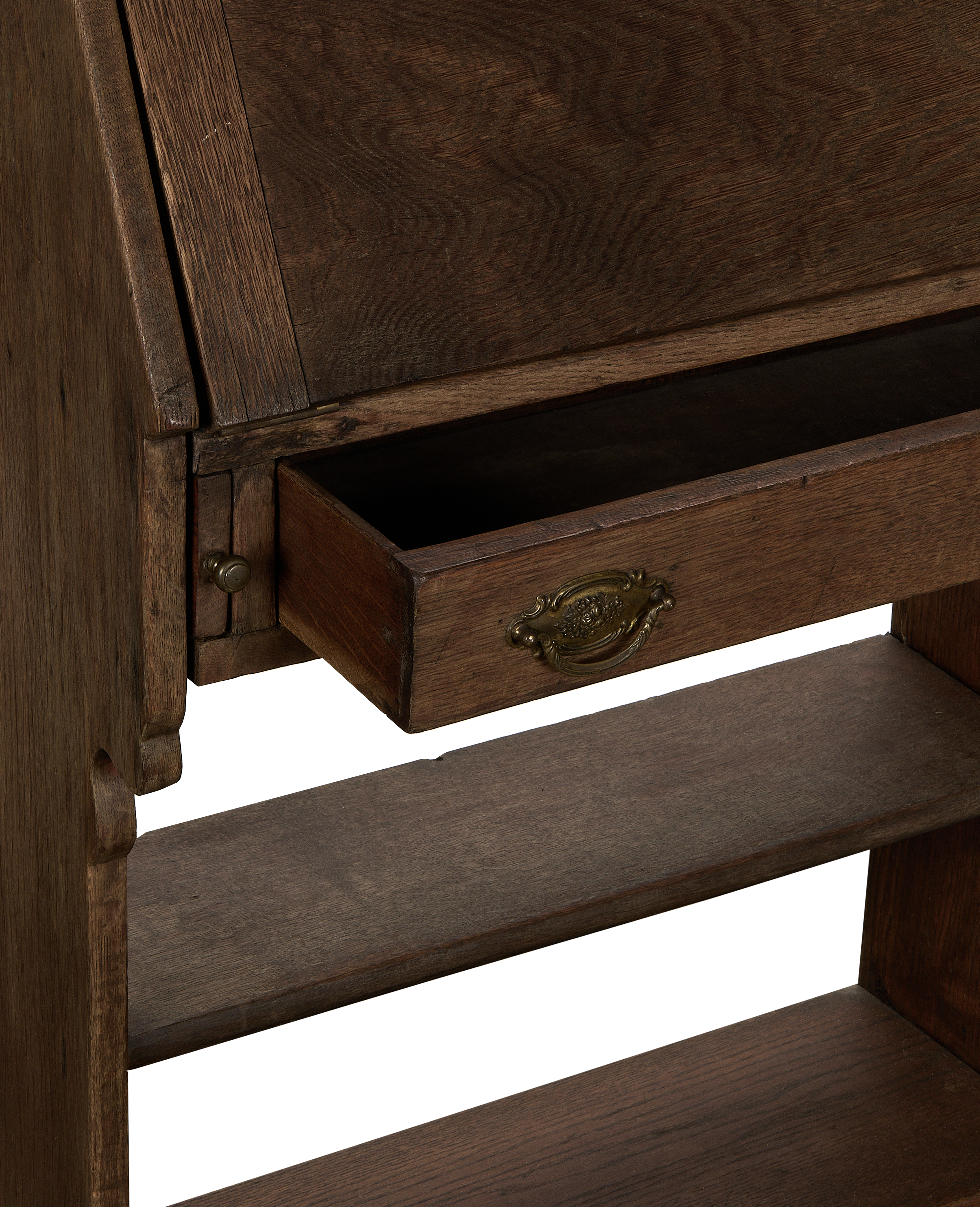Vintage French oak secretary desk with open drawer, detailed brass pull and carved side shelf.