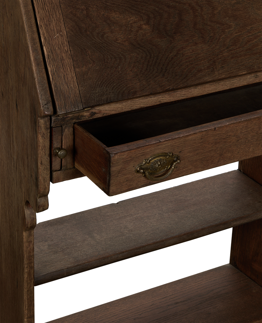 Vintage French oak secretary desk with open drawer, detailed brass pull and carved side shelf.