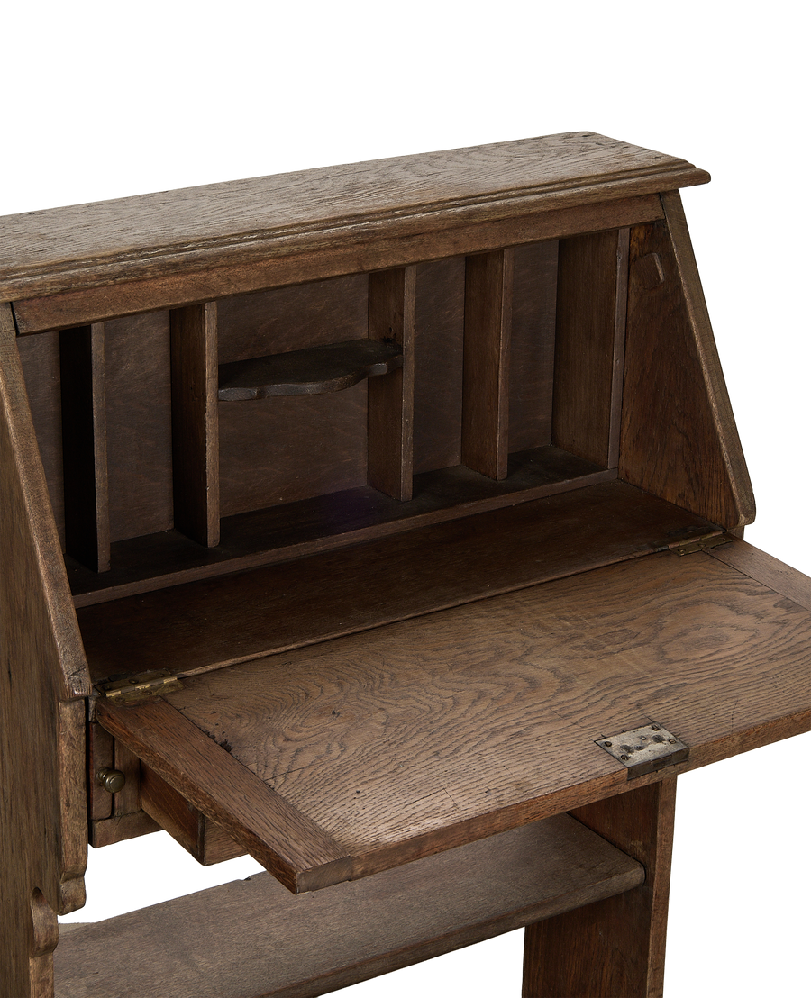 Vintage French oak secretary desk with drop-down writing surface and internal pigeonholes.