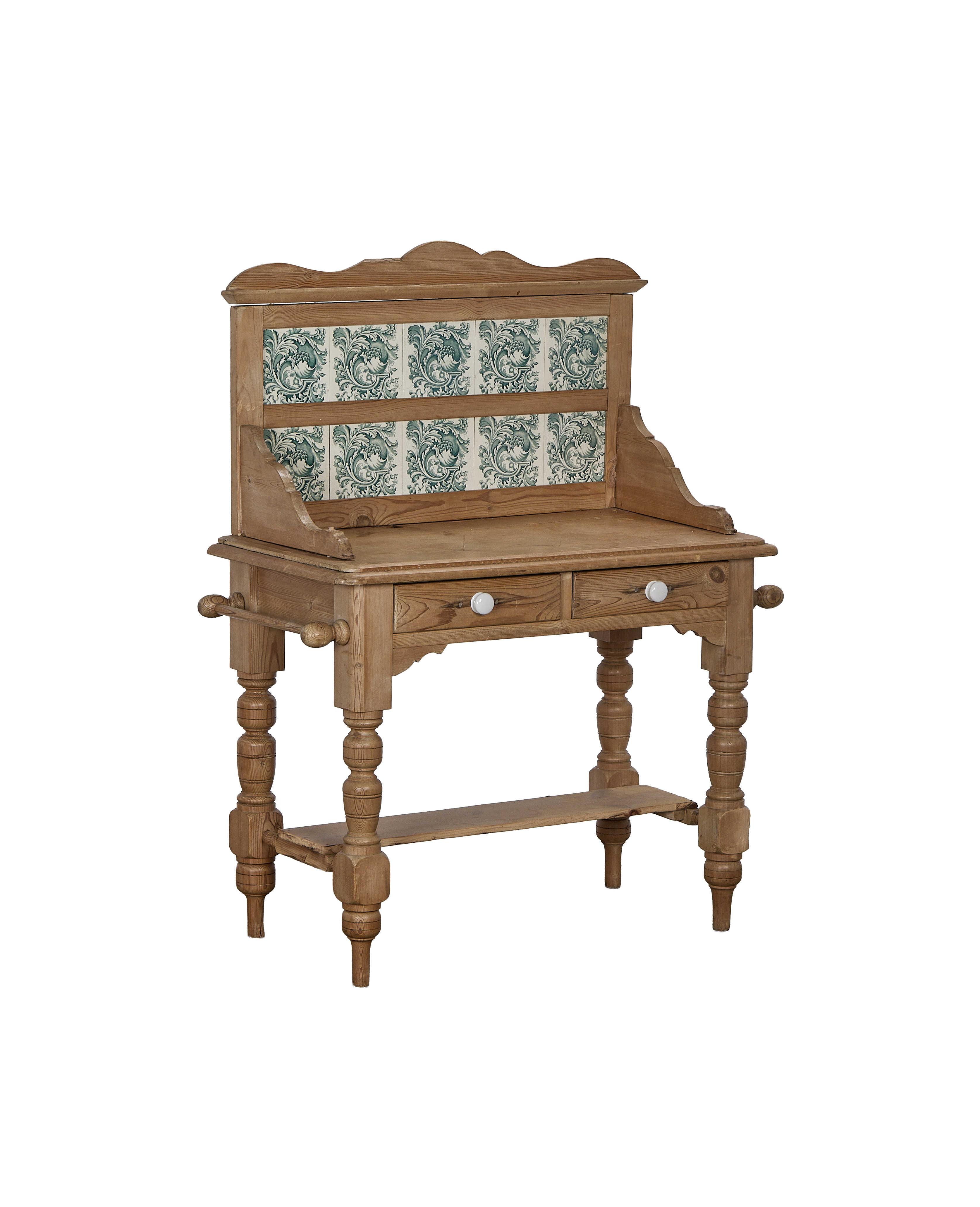 Vintage French oak kitchen cabinet with decorative green and white tiled backsplash and drawers.