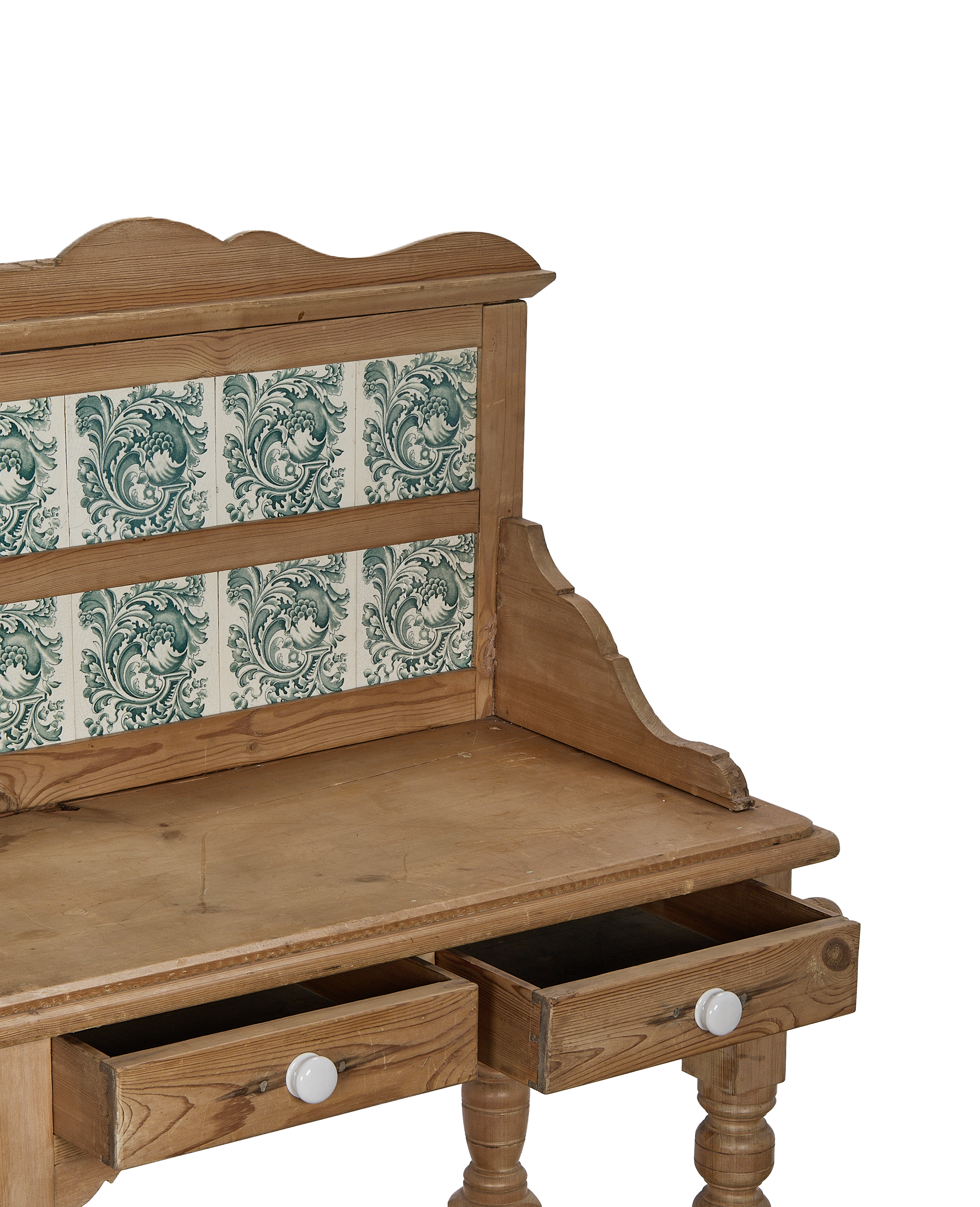 Vintage oak kitchen display cabinet with opening drawers and ornate green tiles.