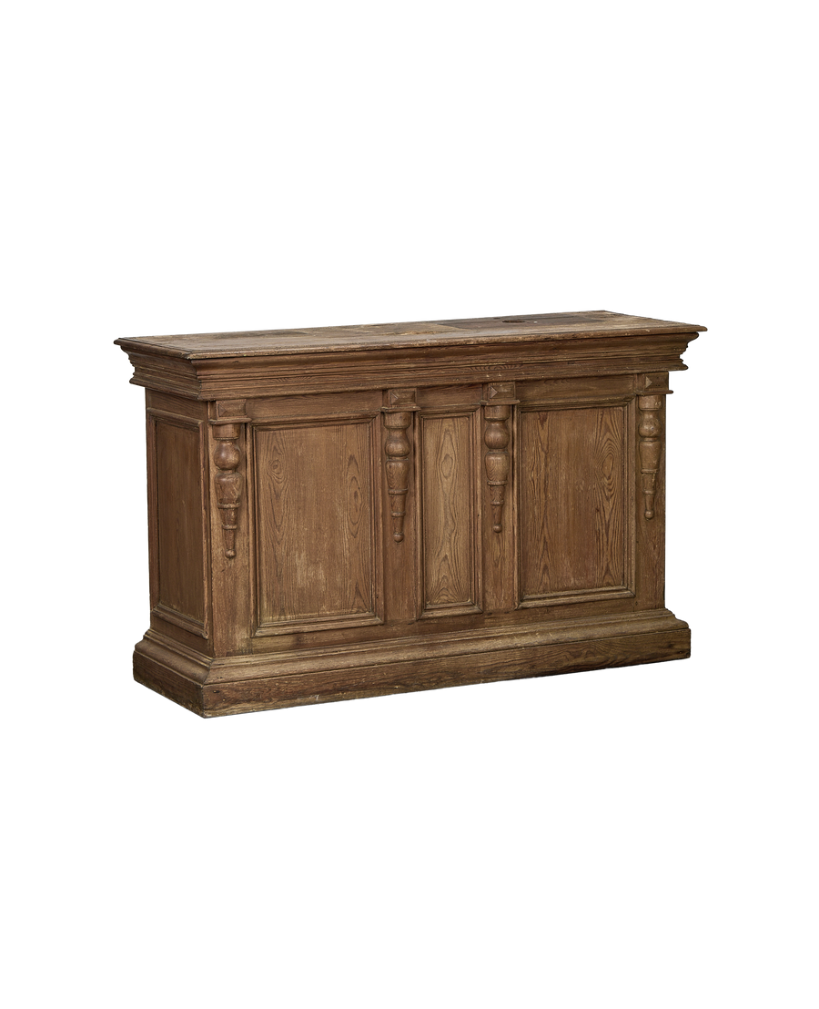 French vintage oak shop counter with detailed carved wooden pilasters and aged patina.