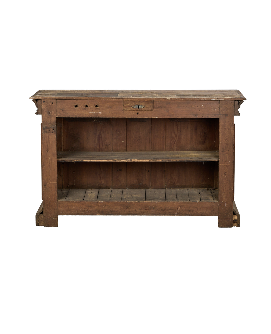 Vintage French oak shop counter from front, showing worn wood, drawer with keyhole.