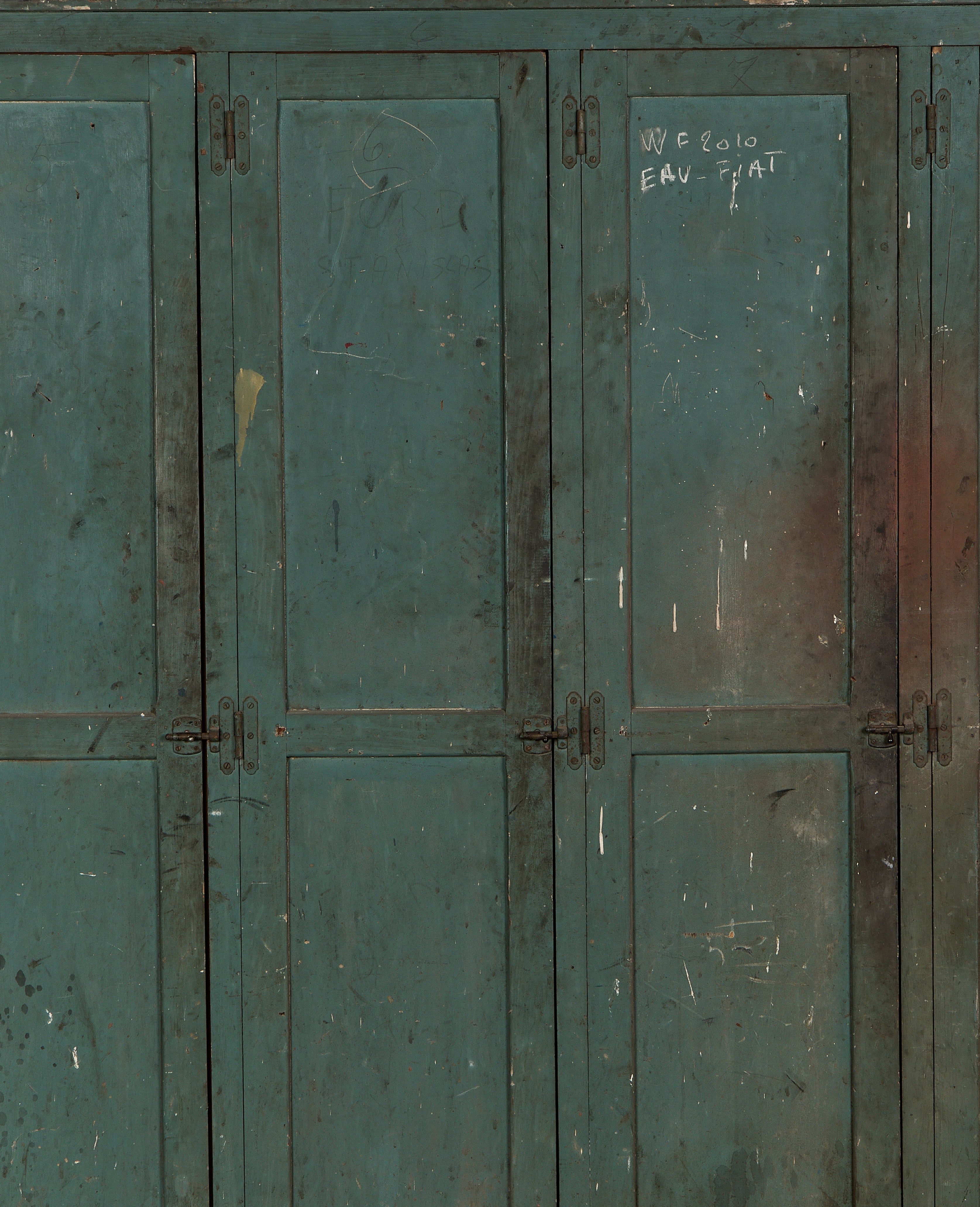 Vintage French oak locker cabinet, distressed teal paint, visible hinge details, and aged patina.