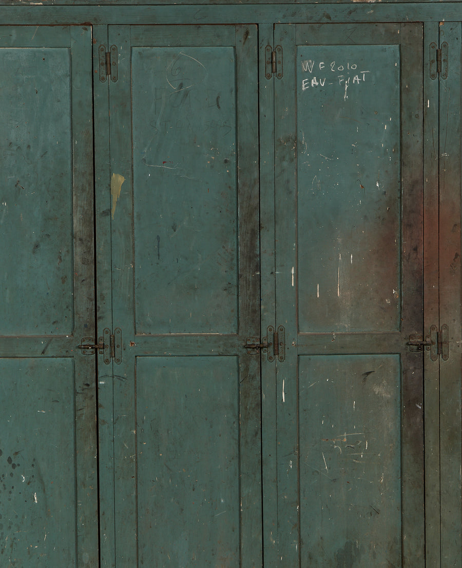Vintage French oak locker cabinet, distressed teal paint, visible hinge details, and aged patina.