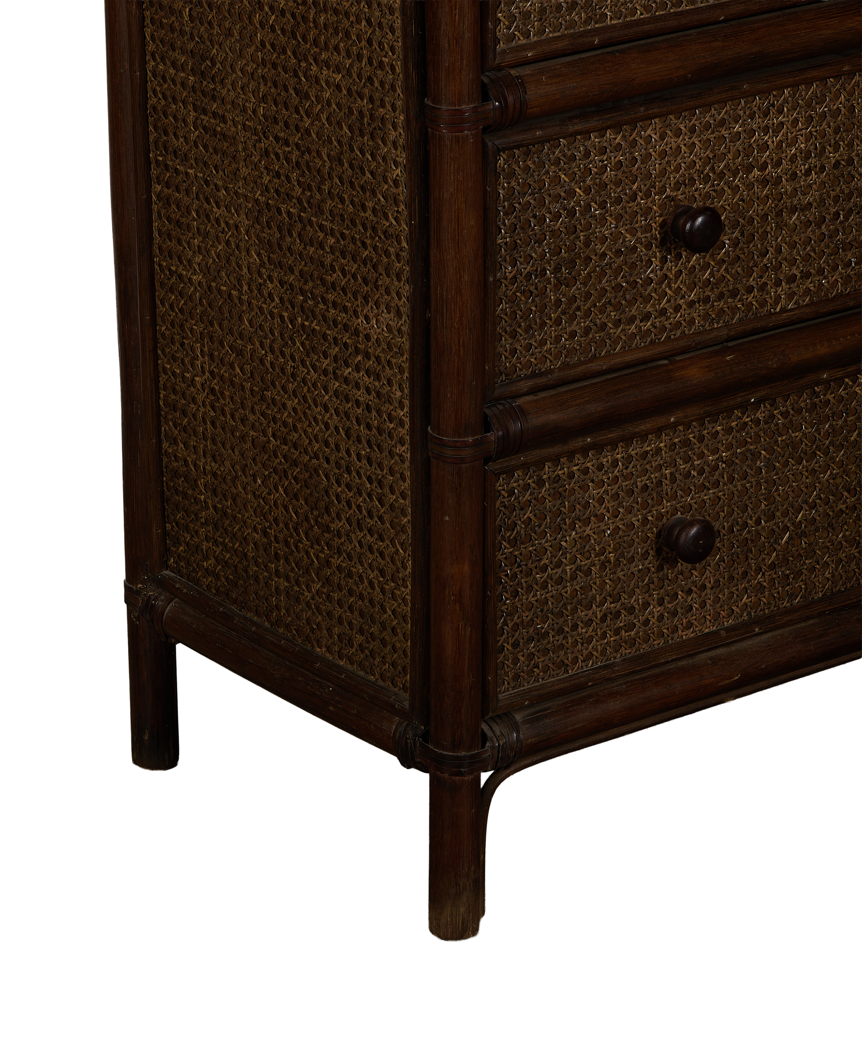 Corner view of vintage French oak and cane inlay dresser, dark wood.
