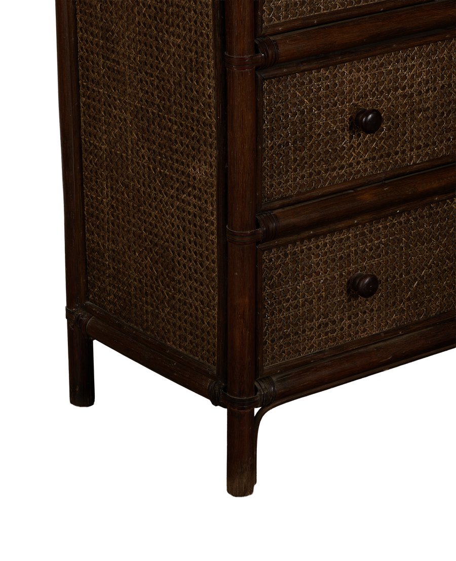 Corner view of vintage French oak and cane inlay dresser, dark wood.