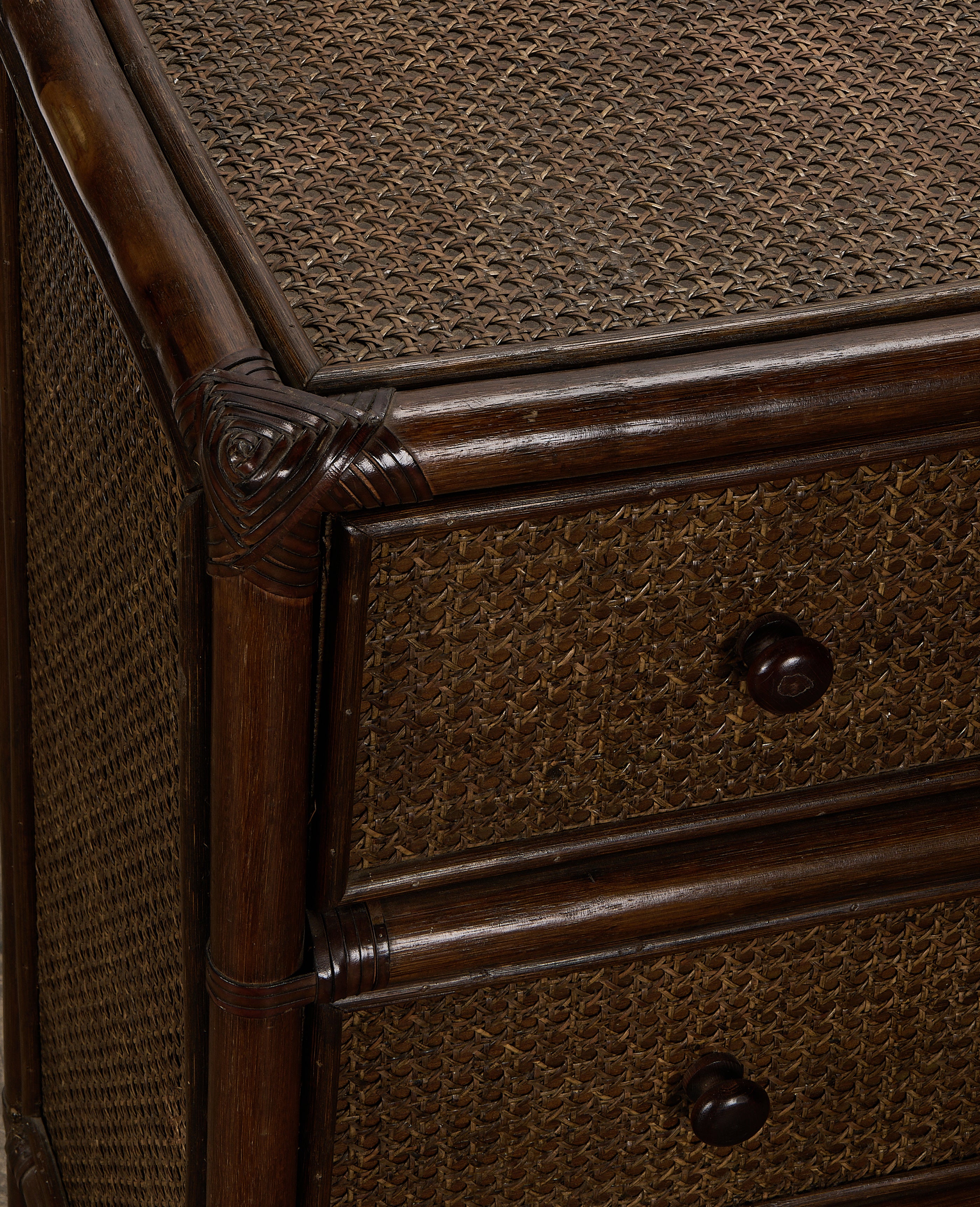 Vintage French woven cane and dark oak dresser, showing drawer pulls and intricate detailing.
