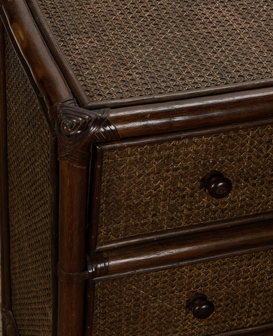 Vintage French woven cane and dark oak dresser, showing drawer pulls and intricate detailing.