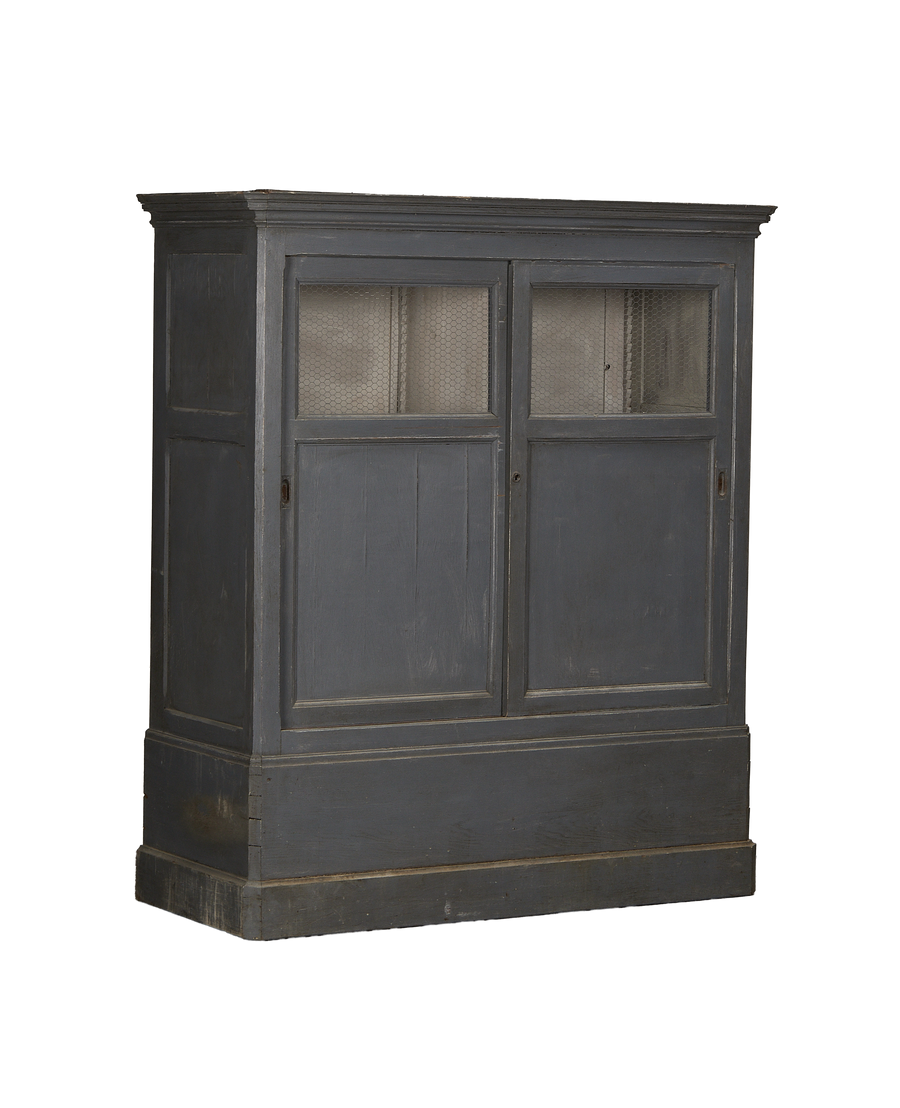 Vintage French oak cabinet, painted gray, featuring screened wire doors and detailed base molding.