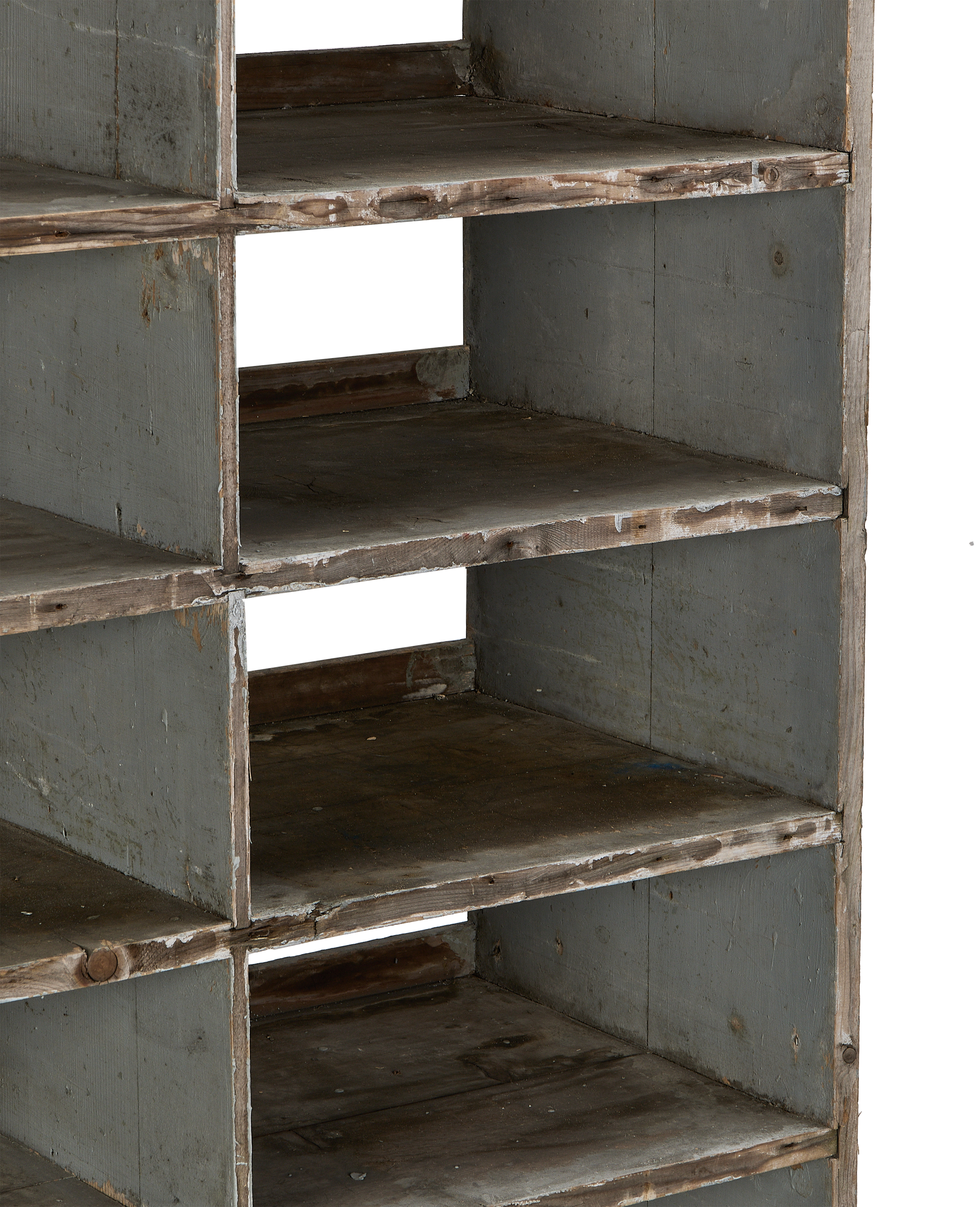 Close-up of vintage French oak shelves, showcasing worn green paint and rustic wood texture.