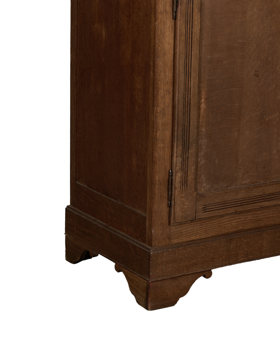 Vintage French Oak wood armoire, detailed base with carved scrolled feet and dark finish.