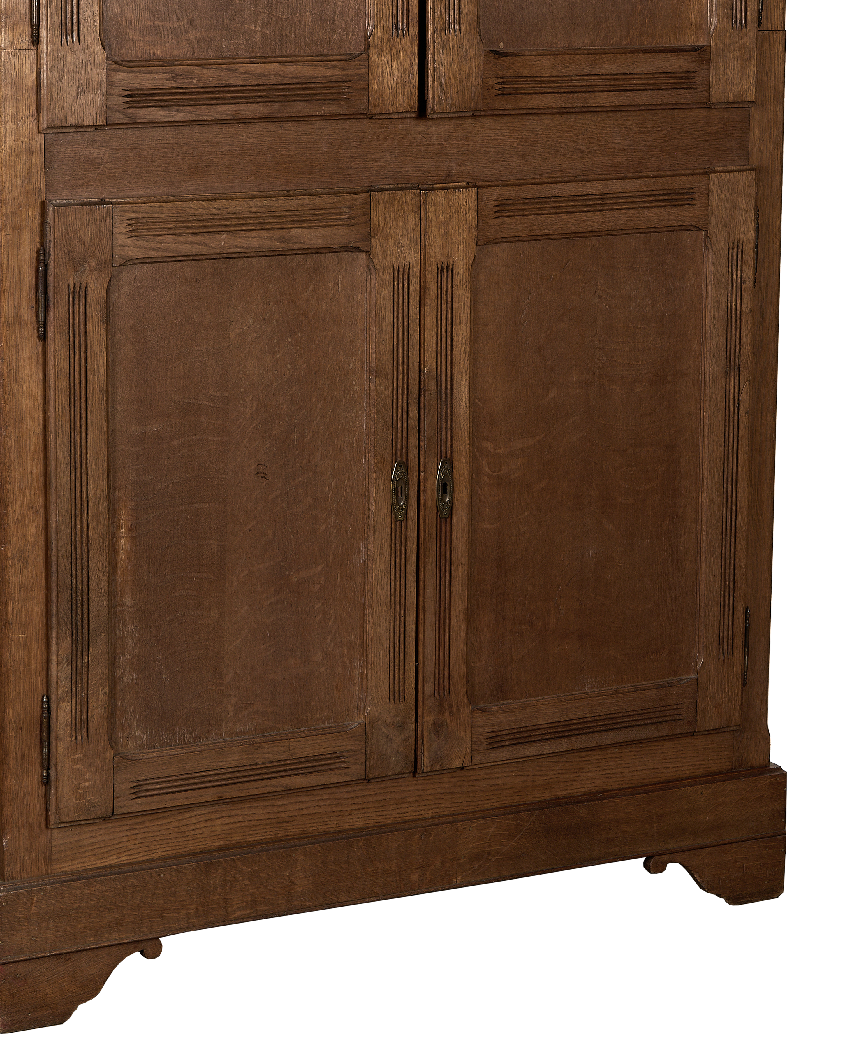 Vintage French oak armoire, close-up of lower doors revealing paneling and keyholes.