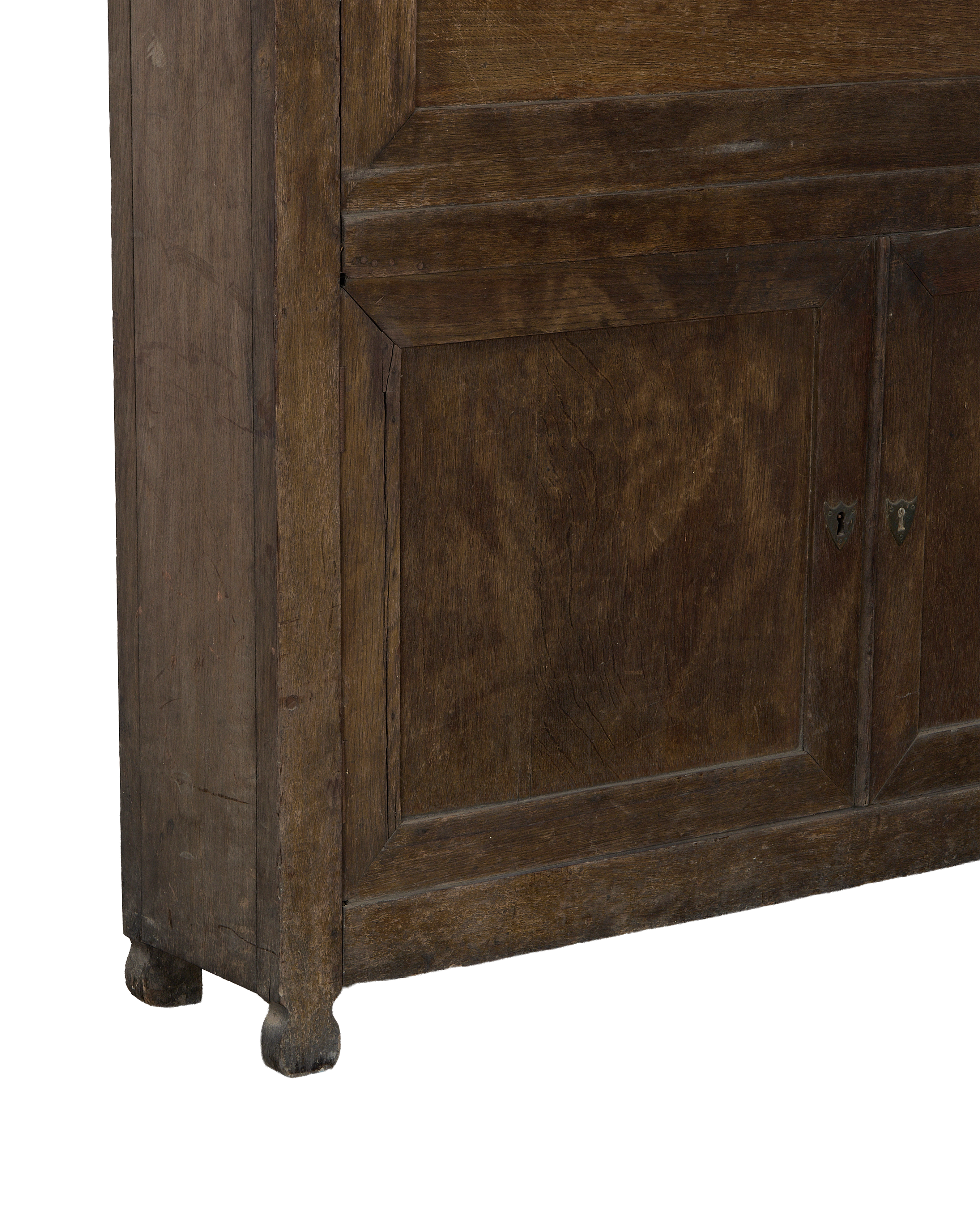 Lower section of French vintage oak desk cabinet, showing turned feet and panels.