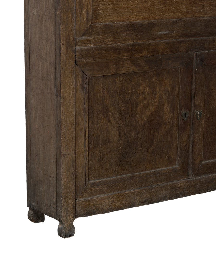 Lower section of French vintage oak desk cabinet, showing turned feet and panels.