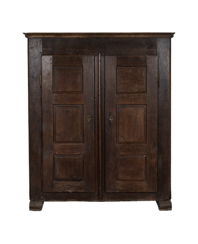 French 1850s vintage oak cabinet with dark patina, paneled doors, and escutcheons.