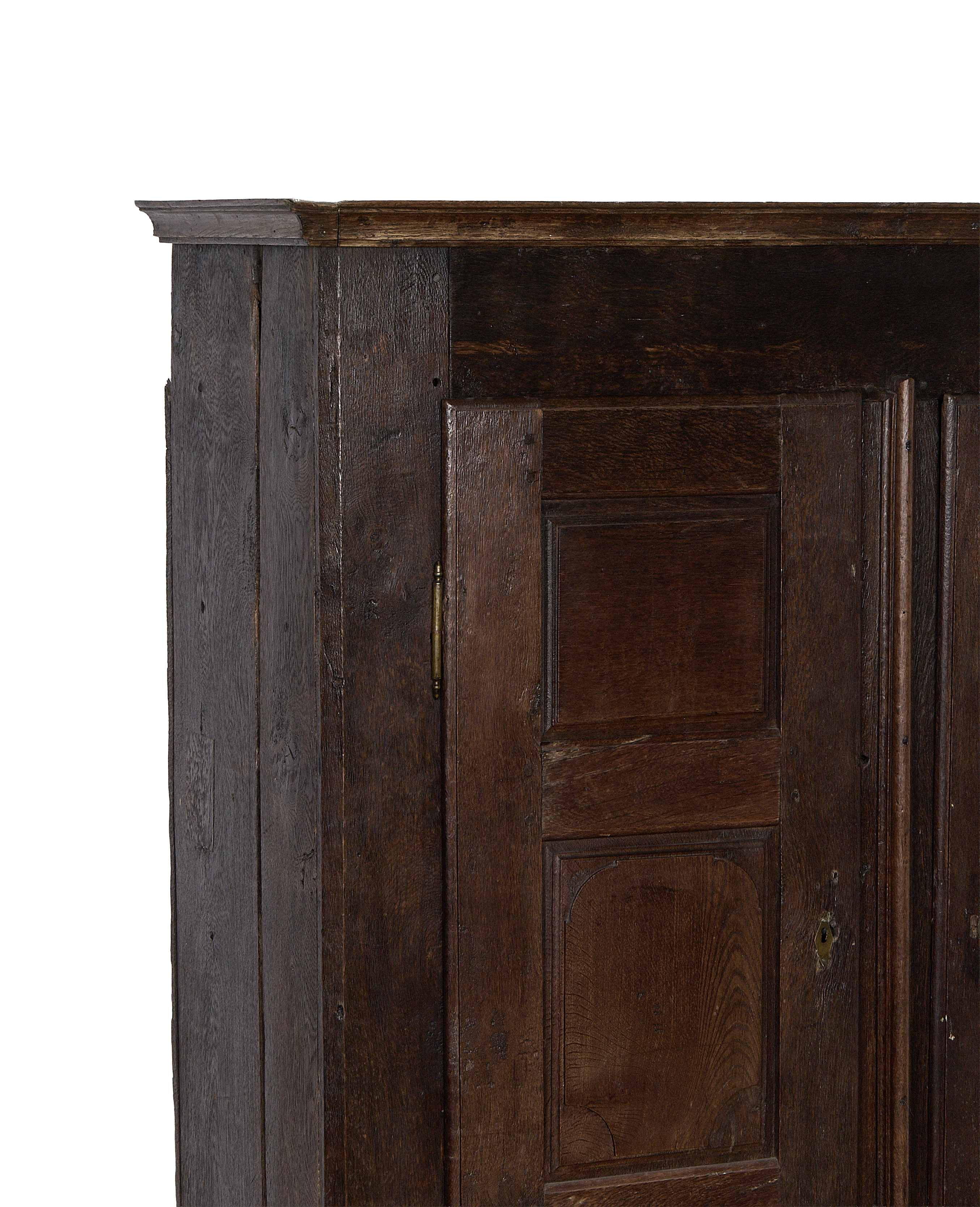 Corner view of the 1850s vintage French oak cabinet, showing brass hinge and lock.