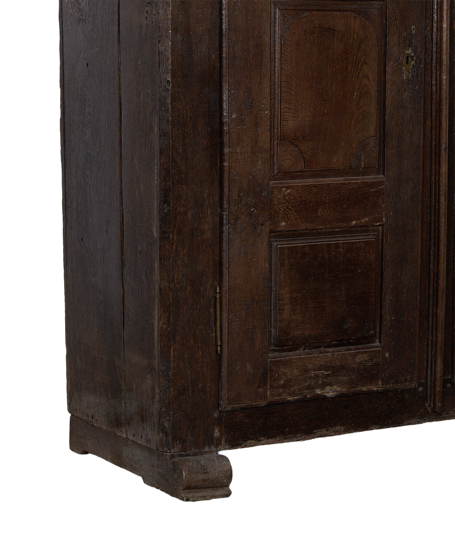 Close-up of vintage 1850s French oak cabinet, showing rustic plank detail and base.