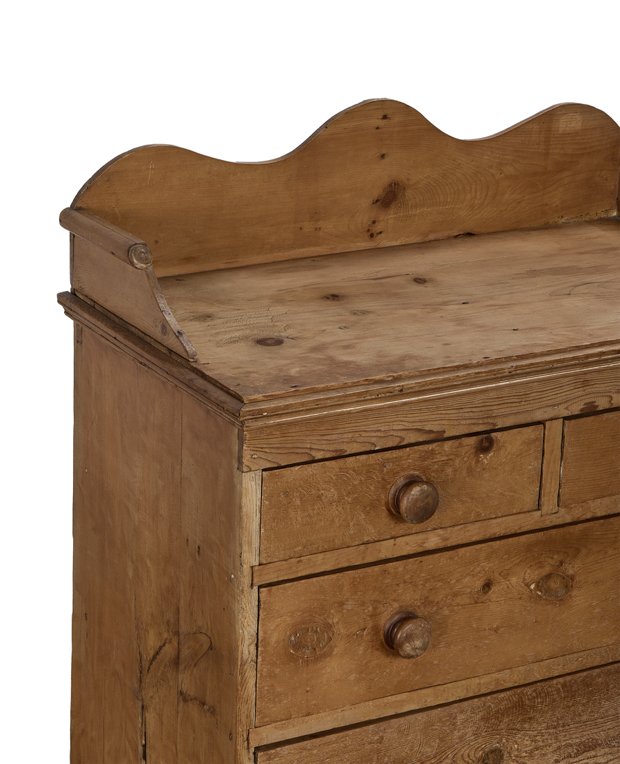 Vintage French pine chest of drawers, showing curved top backboard detail and knob.